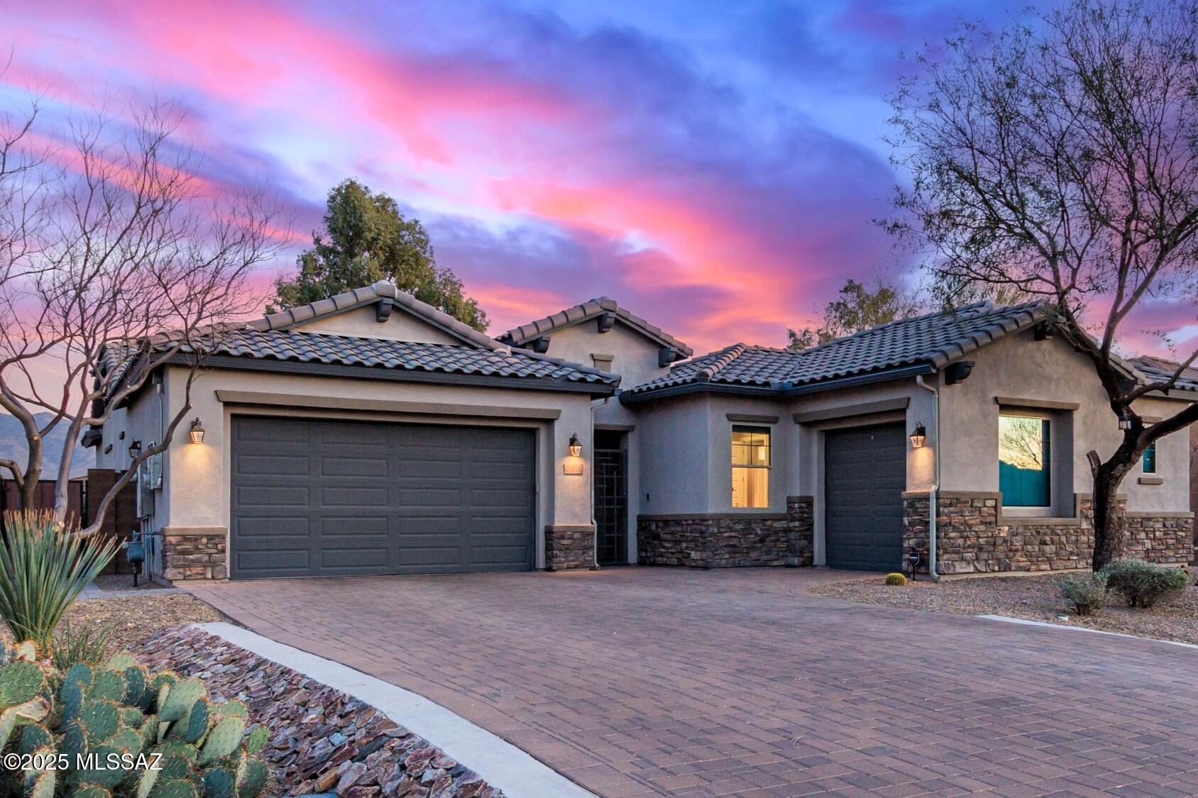 Built in 2018, this extraordinary single-story 4 bed/2.5 bath contemporary home is situated on a private 0.47-acre lot w/ stunning sunrise, sunset & mountain views in the desirable gated Desert Willow Ranch community. Not too big, not too small. This thoughtful floorplan creates an experience that balances open concept light-filled living w/ comfortable, cozy spaces & offers indoor-outdoor enjoyment. With a 3-panel glass slider, large covered patio, built-in BBQ & sparkling pool, you're ready to effortlessly entertain! Incredible gourmet kitchen boasts a large island, TONS of cabinets & counterspace, stainless appliances, gas cooktop & a giant 4' x 13' walk-in pantry w/shelves. Primary suite features your DREAM closet, luxurious shower, dual sinks, picture window & direct access to... ...the resort style backyard. Owned Solar Panels mean you get BIG savings every month PLUS the 2-car garage includes EV Charger, custom shelving & utility sink.  3rd garage space perfect for hobbies, home gym, or extra storage! You'll appreciate the high ceilings throughout, contemporary 8ft doors, tankless water heater, water softener, reverse osmosis, laundry room w/ cabinets & walk-in closets w/built-in shelving in all bedrooms! Energy efficient windows are dressed w/ custom top-down/bottom-up shades & blackout roller shades. Easy access to shopping, restaurants, golf, outdoor recreation & top-rated Tanque Verde schools. Welcome home!