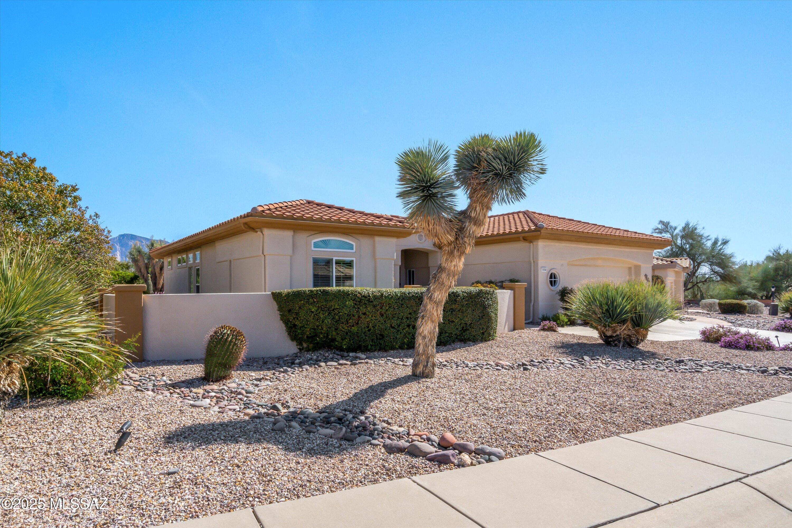 Enjoy spectacular desert living at this gorgeous 2BD/2BA (1,935 sq ft) Sunrise model on premium view lot. Enter to find designer hues, updated kitchen & baths, Italian porcelain tile and wood plank flooring, plus stunning Catalina views from inside & out. Newer HVAC (2022), Milgard windows (2020) and Roof (2015). Desirable open concept plan features overheight ceilings & doors, plantation shutters, recessed art niches, plus walls of windows to accentuate the views. Formal living & dining room with ceiling mounted audio speakers flows to informal Great room with art/media wall. Striking chef's kitchen hosts curved center island, custom cabinetry, granite countertops with porcelain tiled backsplash, light filtering skylight and over/under cabinet accent lighting. Elegant Owner's suite offers wall-to-wall view windows plus wood plank floors. Luxurious bath hosts a huge walk-in shower with striking marble surround, pebble rock floor and glass block window. Extended guest room with wood flooring features a separate sitting room/office with built-in workstation. Additional hall bath, powder room and studio/crafts room off kitchen. Garage houses laundry facilities with sink, attached storage cabinets, workshop area and water softener. Decorative epoxy coating on driveway, front walkway and inside garage. Retreat to a spectacular outdoor living space featuring covered patio with retractable awning, extended flagstone pavers and walkways, trickling fountain, lush landscaping including pink grapefruit & lemon trees plus in-ground irrigation system and landscape lighting. Sun City Active Adult Community.