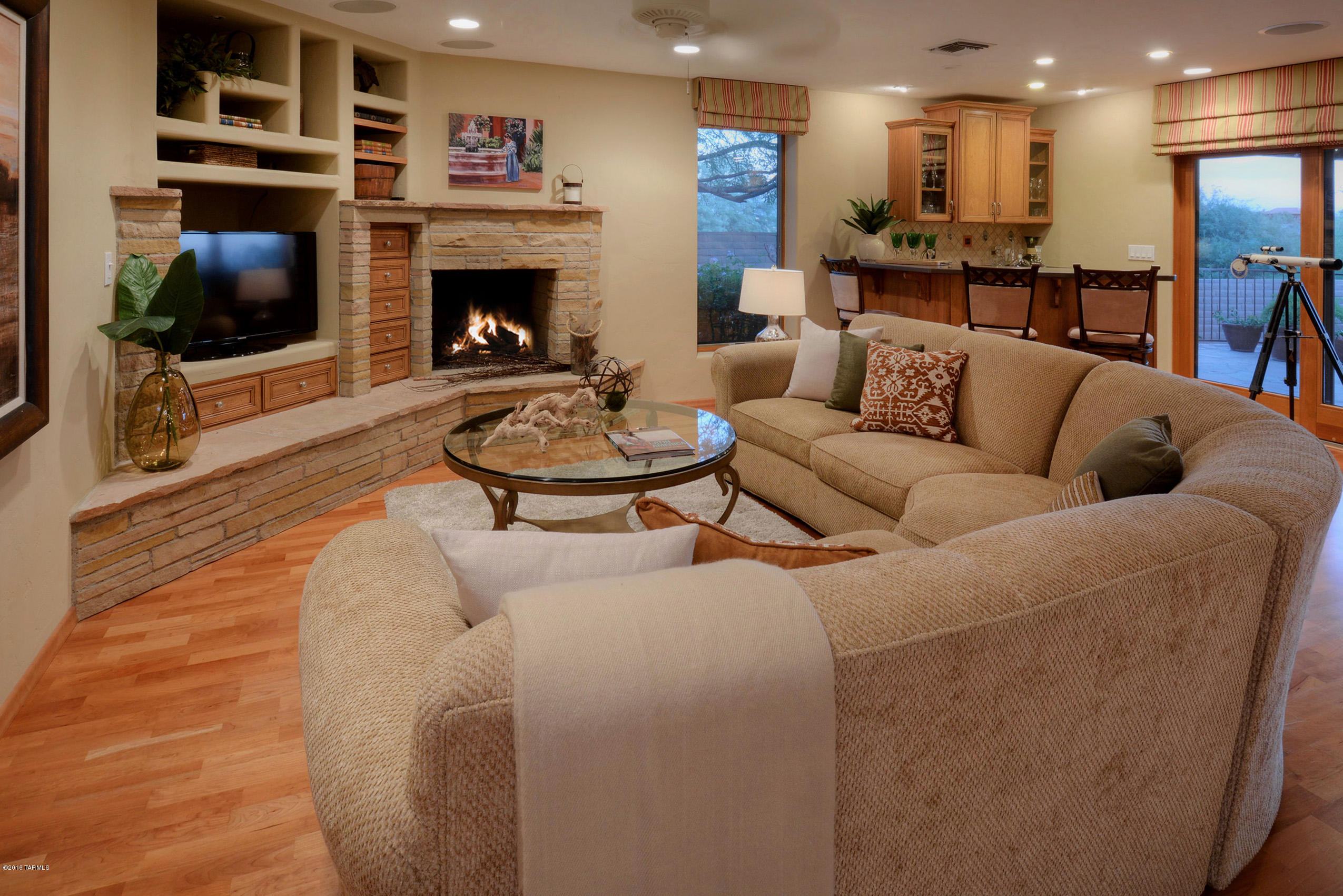 Outstanding, remodeled five bedroom home on a corner view lot in Coronado Foothills Estates. With 3562 sqft, this all masonry home features courtyard entry with water feature, rustic entry doors leading to 22'x22' living/dining room with wood laminate floors and dramatic Catalina Mountain & city views. Gourmet kitchen/family room offers gorgeous custom cabinets, granite counters, designer SS appliances, double ovens, 5 burner gas range, wine cellar, stacked stone fireplace, separate bar w/fridge. Glorious master suite with slate floors, party shower, bidet and custom built-ins. Den/5th bedroom features built-ins and murphy bed. Roof warranty, two new HVAC units in 2015, pool, spa on back porch, custom built-ins in garage, built in grill and burner on east porch and so much more