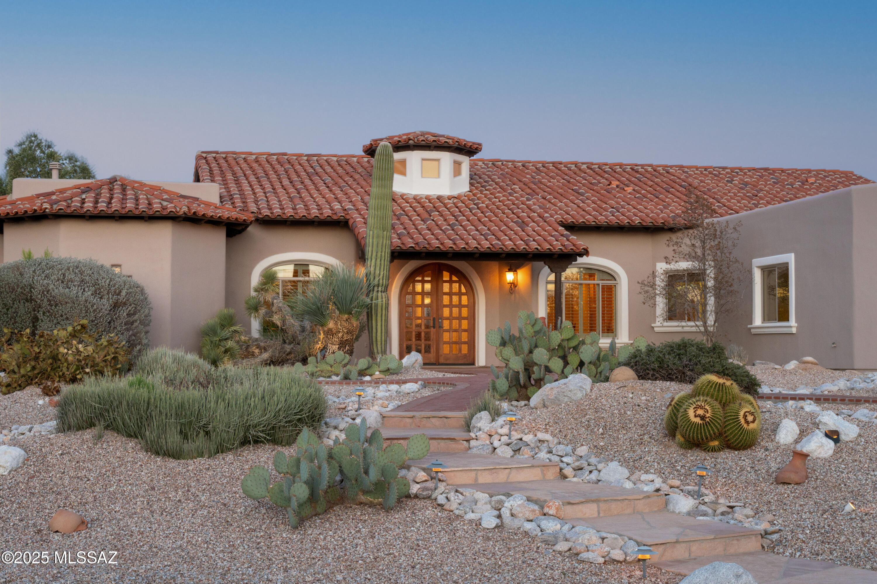 Breath taking views of the Mountains and Canyons through an abundance of picture windows in this beautiful, meticulously maintained Custom build on .99 acres. 3 Bedrooms, 3 Full Baths, 3 Car Garage plus Office/Den. 180-degree unobstructed views of the Catalinas, Rincons, and City with outdoor living areas facing East. Open Concept Kitchen and main living area. Split floor plan with your dream Primary Suite windows facing the mountains and canyon. Beautiful Custom Tile throughout and NO CARPET. 3rd Bay Garage is oversized and could be easily converted to a Studio, 2nd Office, or Home Gym. No Interior Steps! All one level. Move-In Ready.