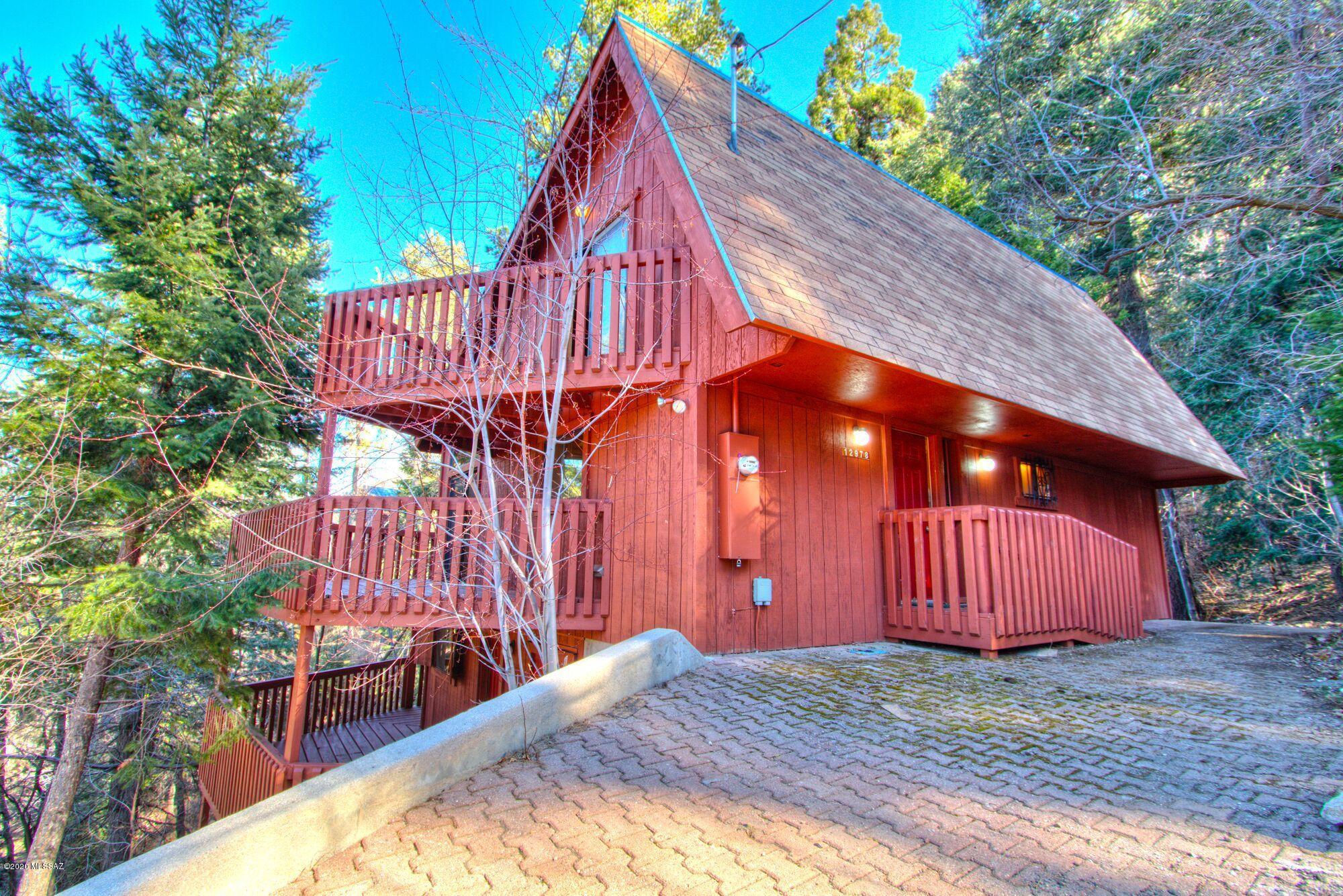 CHECK OUT THE VIRTUAL TOUR! Accepting offers between $300,000-$325,000. Cozy, private cabin nestled in trees of Summerhaven. This charming retreat offers multiple decks for viewing the mountainside. On the main floor; one bedroom, one bath, a large living room, dining area, fireplace and kitchen with pantry, all with a wraparound deck. Upstairs is a loft bedroom, full bath, and bonus area - perfect for games, pool table, or additional sleeping area. Downstairs are guest quarters with private entrance, a second kitchen, dining area, bedroom, bath, and laundry room. Guest quarters offer another wraparound deck, private from the rest of the house. This cabin is an ideal rental property with an owner suite or to rent out the entire home! Perfect summer or winter getaway! Come see tod