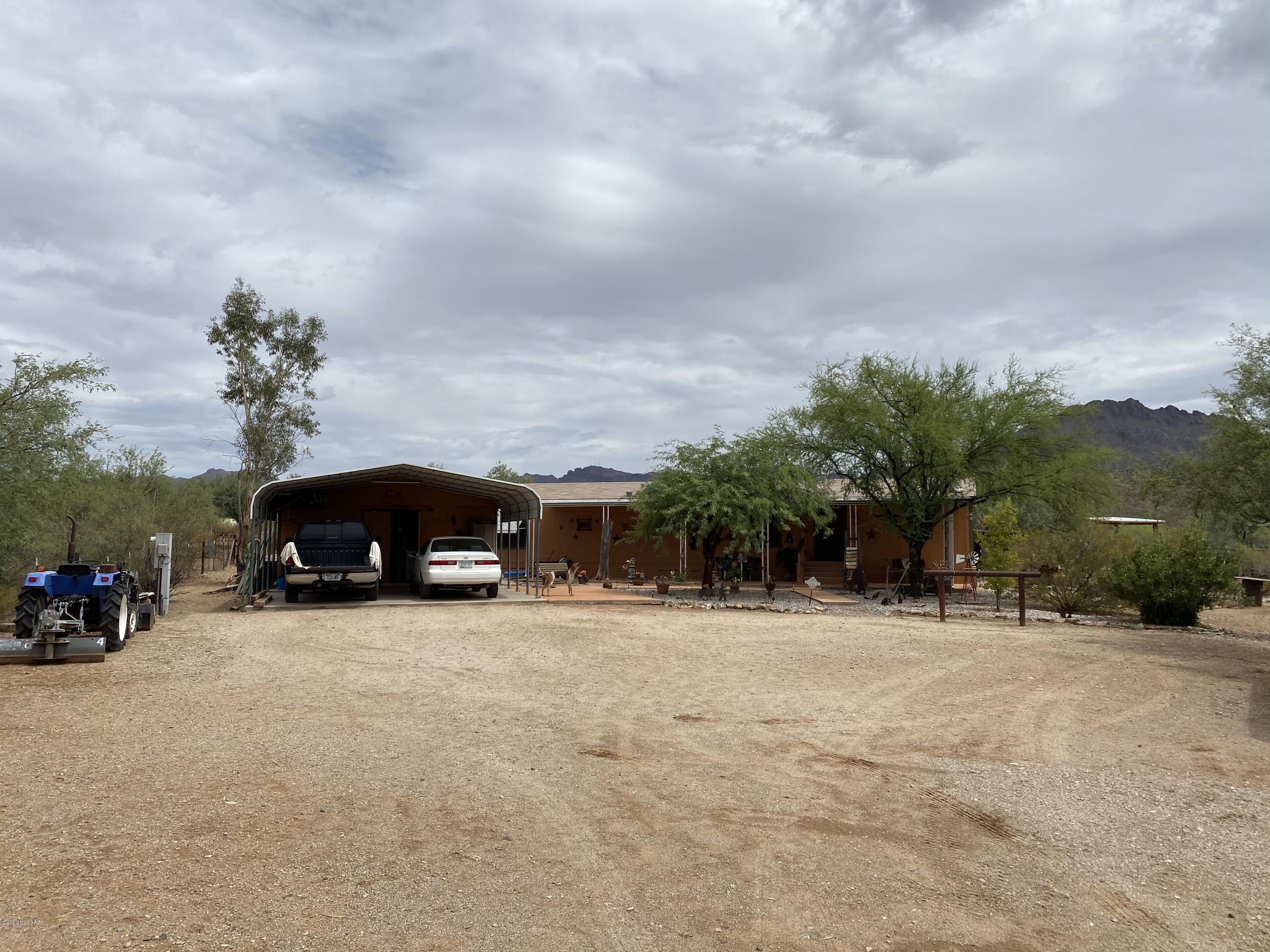 Wonderful 2 Bedroom 2 Bath Manufactured Home on 1 Acre of Beautiful Horse Property w/Gorgeous Sweeping Mountain Views, Riding Trails, Horse Facilities & More! This Great Property has Been Well Maintained & Updated! Nice Open Floor Plan w/Large Living Room, Dining Area, Beautiful Kitchen w/Brkfst Bar, Fridge Included, Newer Laminate & Carpet Flooring, Ceiling Fans in All Rooms, Master Suite w/ Big Master Bath w/Upgraded Shower, Inside Laundry Room, Newer 3 Ton A/C, Roof Recently Maintained, Full Length Front Covered Awning w/Colored Concrete, Great Back Covered Porch, 2 Horse Shade Buildings, Fenced Corral, Hay/Tack Room, Large 2 Car Carport w/Storage Workshop or Outside Laundry Rm, Fully Fenced Lot in a Great Private Location, RV Hookup & No Flood Zone! Come See Today!