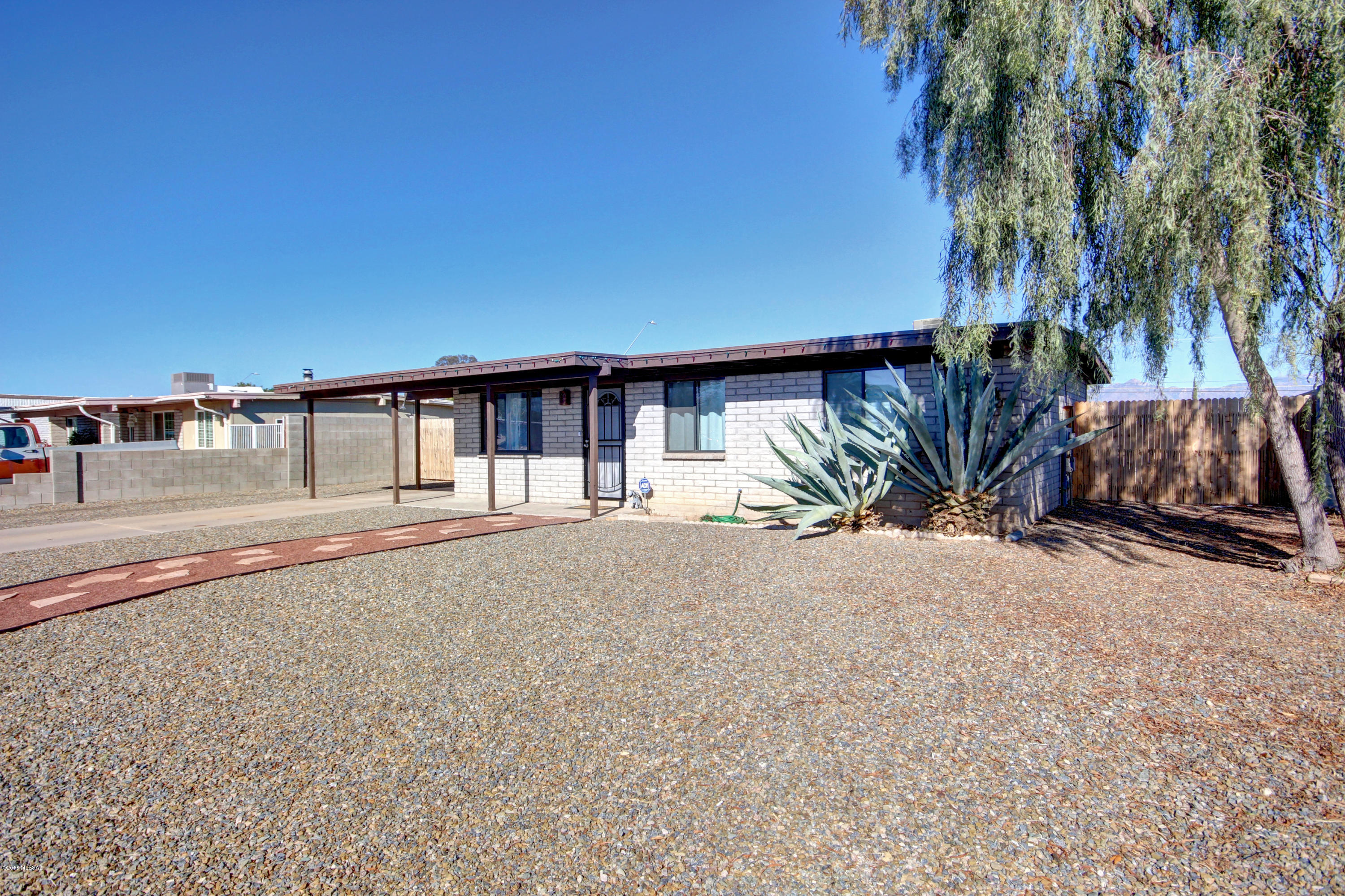 Charming 3 bed 2 bath home in a great Tucson location! Open floor plan with a neutral color palette throughout. Galley style kitchen features white appliances and ample cabinet & counter space. Each spacious bedroom has plush carpeting. Master includes an adjoining bath. Generous backyard is complete with a covered patio, refreshing blue pool, and room for lots of colorful flora! This home is ready for your personal touches!
