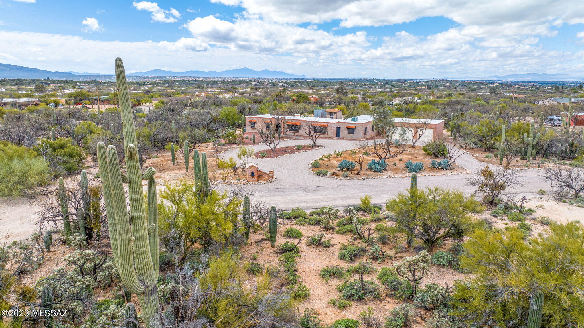 Vintage Northeast Foothills Tucson Home with 5 bedrooms, 3 baths and  an additional room for a home office.  This property has spectacular views of the Catalina Mountains!  Situated on a 3.41 acre parcel, the residence has a split  floor plan with three bedrooms on one end of the home and two bedrooms on the other. This Suite type orientation makes it perfect for a separate living area for family or visitors.  An oversized three car garage allows room for a workbench or hobby area. Outside storage building provides room for even more storage for off season items.  Fenced back yard is perfect for pets and/or a future location for a a pool.