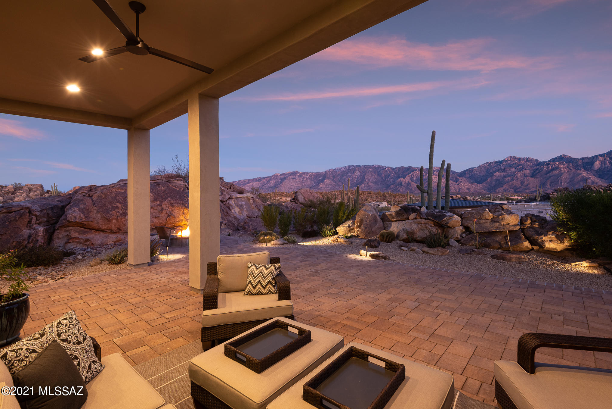 Unrivaled panoramic Pusch Ridge mountain views from this elevated near 1-acre premium homesite from the initial offering at the gated Boulder Vistas at Stone Canyon. This spectacular desert setting is defined by unique rock formations, thousands of giant saguaros & breathtaking mountain views near the acclaimed Stone Canyon Club. This 2018 energy efficient home has a true WOW factor from the moment you enter, delivering remarkable views & privacy coupled w/ thoughtful design & superb execution for the ultimate in desert living.  Driveway lined in pavers leads to covered entry w/ stacked stone & metal accents.  Expertly designed split bedroom floor plan efficiently utilizes space providing a manageable sized home without sacrifice.  Oversized kitchen island w/quartz countertop CLICK MORE .... and breakfast bar is the centerpiece of this upgraded kitchen with stainless steel appliances, walk-in pantry, beautiful cabinetry and custom lighting. Adjacent formal dining area is complimented by wine room with wine cooler and additional storage for dishes and glassware.  Kitchen opens to great room with wood floors and walls of windows that frame the unparalleled and unobstructed mountain views.  Massive retractable glass door opens the wall completely and leads to deep covered wraparound patio with pavers.  Backyard has a turf area and a fire pit for cool desert nights.  Large boulders enclose the backyard for a natural barrier. 

Generous sized master suite with mountain views has a spa inspired master bath w/ huge glass enclosed shower, his and hers vanities with tons of counter and storage space, beautiful tile floors and walk-in master closet. 2 additional en-suite guest bedrooms tile surround showers and glass enclosures.  Den area off of entry is a flexible space for an office or whatever will meet your needs.  

Laundry room with storage cabinets and sink. 2-car garage.  Ask Listing Agent for details on energy efficient features. Nature, privacy and serenity all within proximity of restaurants, shops and much more.  

Award winning Stone Canyon Club is consistently ranked among the top golf courses in the country.  In addition to the Mickelson 18-hole golf course enjoy a fitness center with modern work-out facilities, classes, tennis courts, pickle-ball, lap pool, yoga, pilates and spa services.