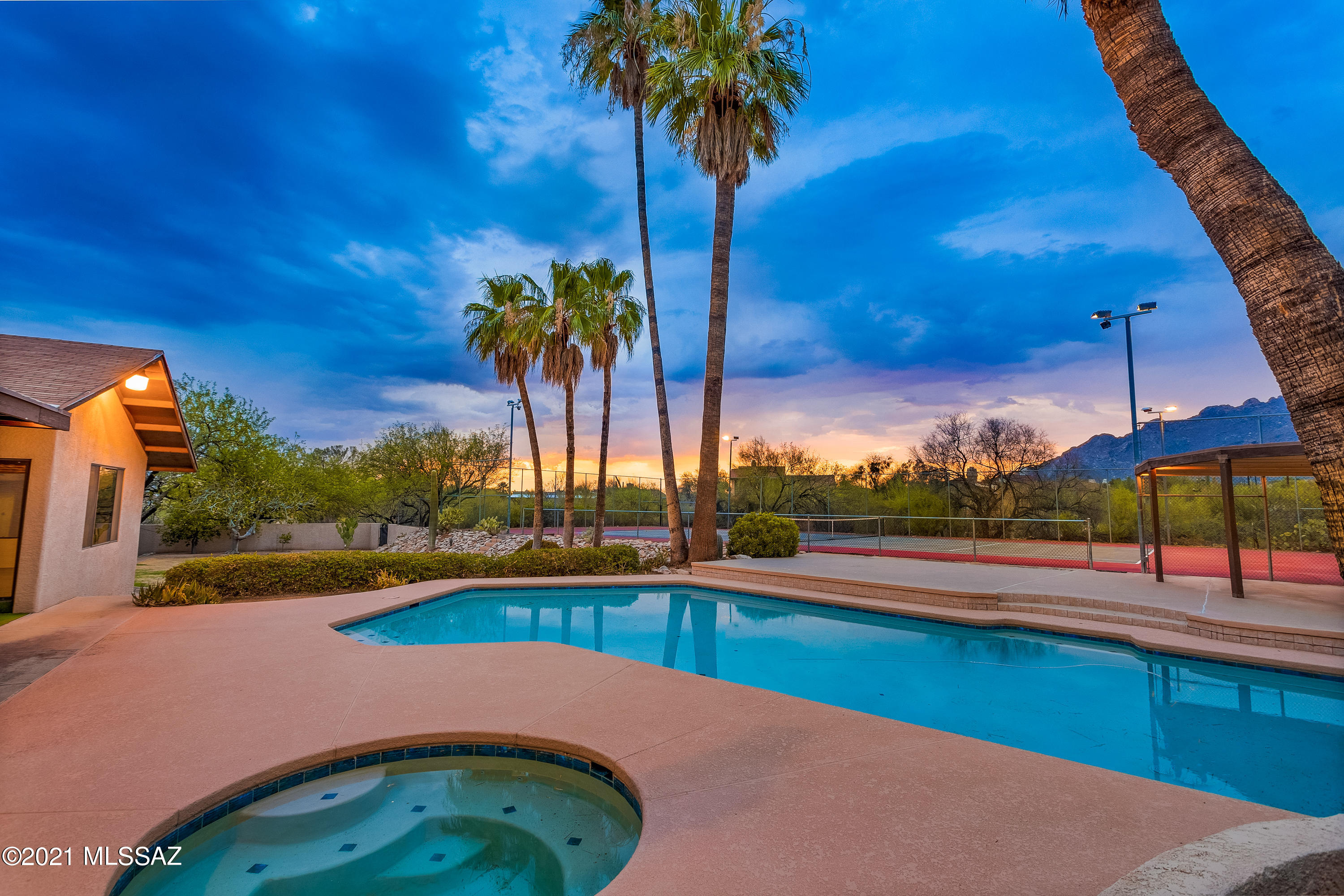 First time on market in sought-after Shadow Hills! Nestled on 1.15 acres at the end of a quiet cul-de-sac, this spacious 3530 sqft 4bd/2.5ba + 5 car garage home boasts the ultimate in resort amenities w/astounding Catalina mountain views! Swim laps in the expansive 40' pool, play tennis on the lighted court, relax in the spa and watch the mountains turn pink.  Detached 3 car garage/shop provides 5 total garage spaces.  Estate property presents an amazing opportunity to update to your taste on a premium lot in a top-rated school district. The master bedroom is a private retreat with beehive fireplace, office space, spa-bath and mountain views.  Three additional bedrooms are all large (12x15) with walk-in closets. Appealing floor plan with sturdy 2x6 construction, R-30 insulated walls and custom Imperial plasterwork (no drywall). Dual laundry rooms and tons of storage are great for a growing family.  

Built for entertaining, the living spaces flow indoor and out with covered patio, sweeping lawn and a sizeable ramada for outdoor kitchen. Bring your imagination to life and you'll be living at the pinnacle property of Shadow Hills with unrivaled views and privacy. Located in prized Catalina Foothills District 16, close to La Encantada restaurants, shopping, Rillito River Path, The Loop, Sabino Canyon, downtown Tucson and much more!