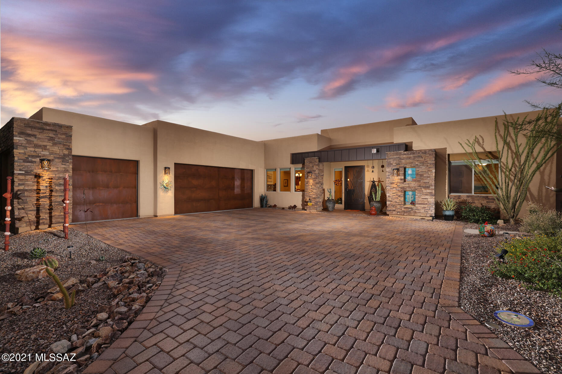 Welcome to paradise! The lush, studded saguaro landscape is quiet and private. This impeccable, designer home has Carly Quinn tiles to greet you, is in a gated community & located at the end of a cul-de-sac. Three separate & secluded en-suites have nine-foot knotty alder doors, wood plank ceramic tile throughout & a flex room that can be offered as a den or office. The owner's en-suite has a roll-in shower with access to the pool. The spacious chef's kitchen boasts a beautiful granite island with a vegetable sink, stainless steel GE Profile appliances, a U-line wine fridge and a separate five-burner gas cooktop with a breakfast bar that flows into the great room & formal dining room for easy entertaining. Cathedral ceilings and glass sliders open to the covered patio with the finest finishes of travertine & stone. The fire pit will mesmerize you as you relax and gaze at the stars. There are three water bowls that trickle & dance into the pool. Built to enhance livability, you will find a spacious laundry and plenty of storage, a three-car garage, water softener & dual HVACs with humidifiers on the furnaces. Nestled in the foothills of the Tortolita Mountains, conveniently over the ridge, you can access the first tee and are just minutes away from Cayton's Bistro at the Ritz-Carlton Golf Club at Dove Mountain.