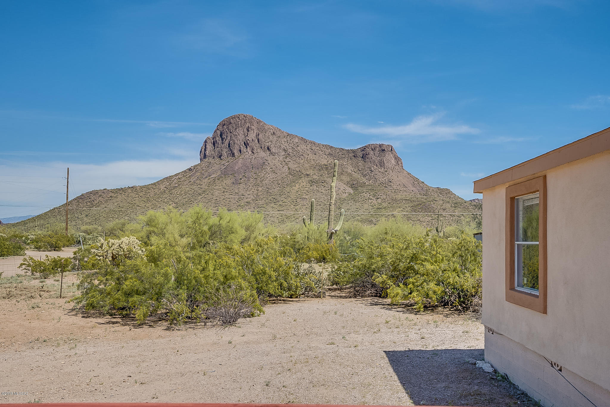 Almost one fenced acre, tremendous mountain views & horse property... what
more could you ask for!! This newly updated 3 bedroom, 2 full bath
manufactured home in Picture Rocks features new flooring, completely
remodeled guest bathroom & fresh paint throughout entire home. Large
raised wooden deck at the front door provides glorious views of local
mountains! Abundant natural light bathes the interior of this home through
windows that allow wonderful panoramic views of the natural desert
landscape of the property & nearby Sombrero Peak. Several out-buildings
provide additional storage as well as a mobile trailer on the property
serving as storage space & workshop.