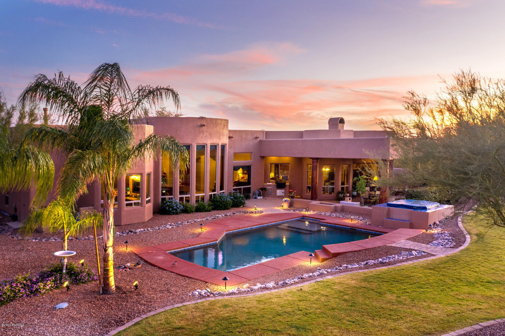 Private but close to city amenities! Custom 4 bedroom, 3.5 bath, 3,579 sqft home sits on over 4.25 acres with glorious unobstructed views of the Pusch Ridge, Tortolita Mountains and colorful  sunsets. Constructed in 2004 in classic Mediterranean style, the main residence features design elements unique to the area, including circular paver driveway, gated adobe brick courtyard with steel double doors, 3 car garage, room for RV parking, & equestrian privileges. Also significant are window walls, 18in travertine tile throughout, knotty alder interior doors, 12-14ft ceilings, custom hardware & custom cabinets with crown molding. A balanced, free-flowing design in the great room, coffered ceilings in formal dining/living room & double sliders leading to the relaxing outdoor living space. Everywhere, amply proportioned windows and glass doors allow bursts of natural light to soften and envelop the spaces and connect them with the outdoors. The meticulously designed chefs' kitchen features built-in stainless steel appliances, breakfast bar, breakfast nook with radius window walls, large prep island, walk-in pantry, granite countertops and custom cabinetry with crown molding. A gracious owner's suite with a large master bath, two executive height vanities, jetted tub, and walk in closet. Two bedrooms share a jack & jill bath and a fourth bedroom features ensuite bath. The property also offers a solar heated PebbleTec pool with spa and elevated spillway, walled yard with grassy area & majestic towering Saguaros. The current owners have been loving stewards that created an inviting retreat for entertaining and celebrations. Explore the home now from your smartphone simply click on the immersive 3D tour.