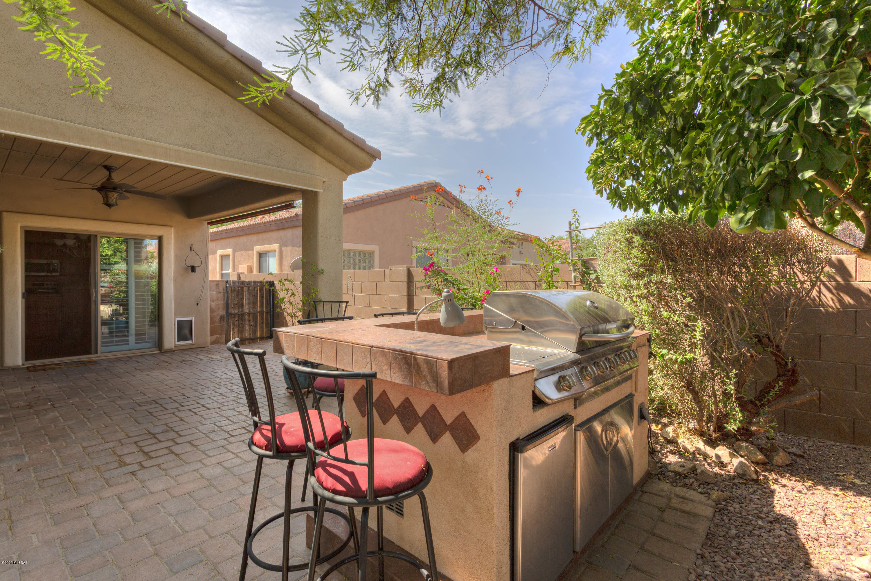 Discover the fun lifestyle offered at Rancho Sahuarita. You will all enjoy swimming and splashing at pools, water park and splash pads. Toss the ball around at a neighborhood park, work out at the fitness center, swish through curves at the skatepark, go fishing or take a stroll around Sahuarita Lake. This single-story, three bedroom, two bath home features an inviting, open great room which adjoins the spacious kitchen and a comfortable dining area. Windows are dressed with plantation shutters. The laundry room includes a washer and dryer, additional built-in custom storage, a soak tub and a chest freezer. Host the ultimate gatherings at the outdoor bar and kitchen or sit and relax around the firepit and roast marshmallows.