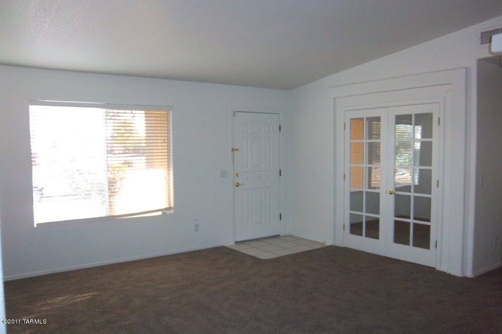 Spacious Home with 3 Bedroom/Den with Glass French Doors. This home has it all. Great Room plus Breakfast Bar, Dining area with Bay Window off Kitchen & Living room . All make room for a Great Open Floor Plan. Split bedroom design & 2 car garage. Newer Carpet. Front and rear are nicely landscaped with Lg Shade Trees and a touch of Grass. Large covered patio.