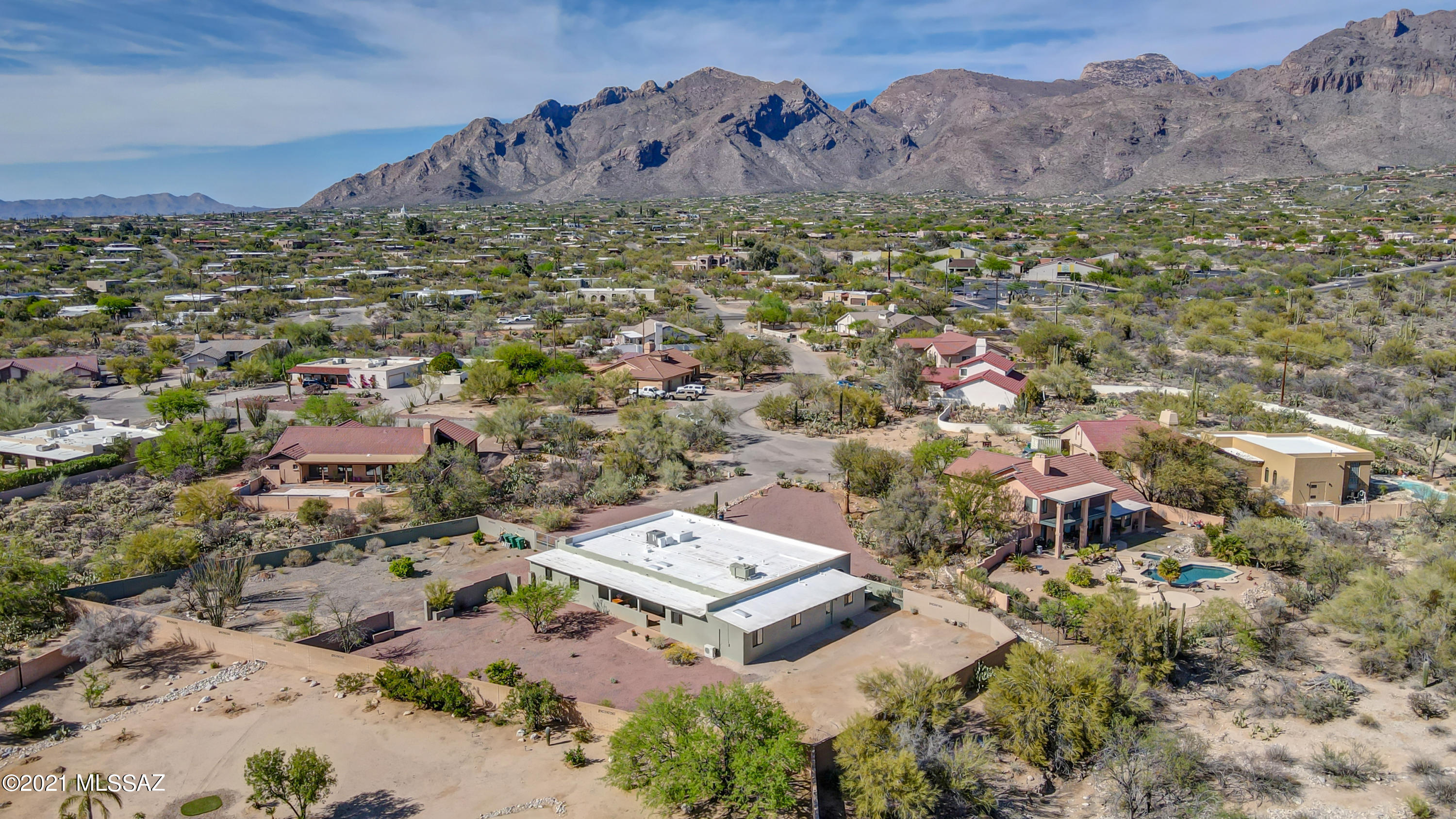 Classic Foothills Ranch with attached GUESTHOUSE on .9 acre view lot completely renovated. No detail overlooked. Versatile layout, Split bdrm plan dazzles from new floors to new cabinetry, appliances, lighting, paint/trim/texture, 2 new A/C's- every detail is impeccable. Kitchen next to formal dining w/ stainless farm sink & peninsula. Huge great room w/ dramatic beamed ceilings, fireplace & hearth. 2 covered patios. Enormous owner's suite w/ fire-place, 3 w/i closets, a sunny extra room, big w/i shower and dual sinks. Laundry room. Large 2nd and 3rd bdrms, one w/ bonus room, full bth in the middle w/ 2 sinks. Guest quarters with bed, bath, kitchen and living room is accessible from home and outside: Possibilities are endless! Unbelievable Lot ready for your stamp. RV gate. Dist 16 Schools The benefits of a complete renovation while maintaining the integrity of the home's beautiful foothills charm. Newly painted and stucco'ed slump block is sturdy and energy efficient. Must see to grasp the beauty. So clean and fresh, the attention to detail shows. Roof has been reconditioned with 3 yr warranty, HVAC with 2 new systems and a 10 year guarantee. Garage has painted floor, storage cabinets and a workshop. Located walking distance to Orange Grove Middle School. Minutes to upscale shopping. Peaceful Cul De Sac. The incredibly large lot is private, and a blank canvas with so many options. This is a buyers dream, and won't last. Call agent for private showings, or use lock box.