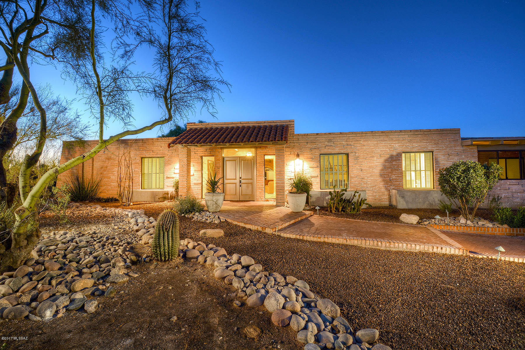 Stunningly remodeled and updated burnt adobe territorial located at the end of a cul-de-sac in Catalina Foothills Estates #8. With 4 bedrooms, plus office, plus Arizona Room, this ''Wow!'' house features brick walkway with all new landscaping leading into grand Foyer (imagine your grand piano here) with exposed and white washed burnt adobe walls and matching wood laminate floors. Formal living room with beamed ceiling, formal dining room and grand kitchen/family room combo with beehive fireplace, wet bar with built-ins and wine frig, built-in desk, all new cabinets and fixtures, granite and butcher block countertops, glass backsplash, center island with breakfast bar, stainless steel appliances including professional gas range. Glorious master suite offers all new master bath with European-style built-in closets, travertine counters and surrounds and adjacent grand office with built-ins and access to rear porch. All new baths, fixtures, paint, flooring, oversized 3 car garage with generous storage, expansive rear porch, brand new pool and landscaping, city and mountain views. A must see for those wanting vintage burnt adobe charm in the foothills, yet with remodeled, contemporary flair.