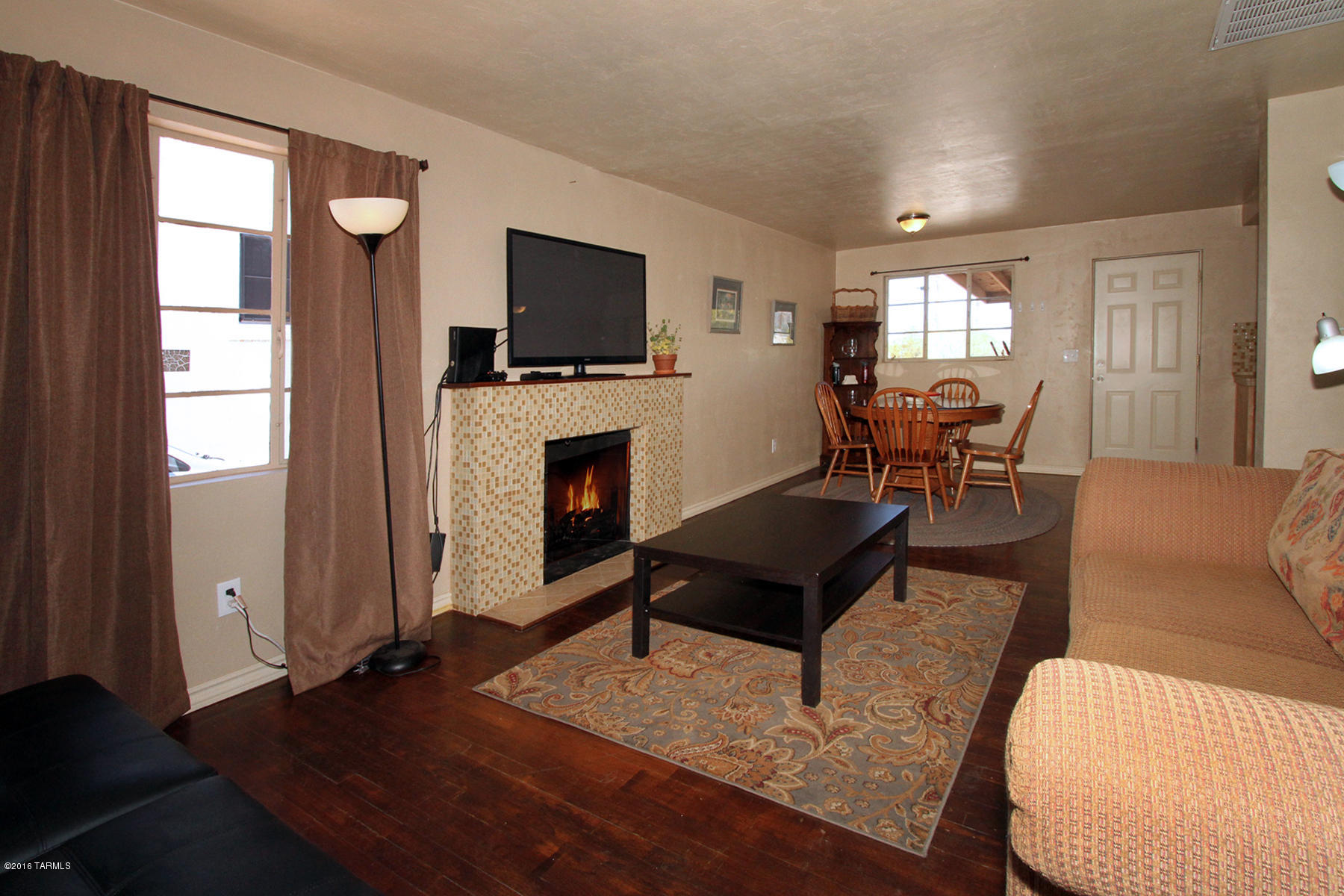 Remodeled, well cared for 3 Br/2 Bath just north of the University. Remodeled kitchen with glass tile backsplash. Remodeled baths with tile and accents. Covered front patio with Saltillo tile. Covered rear porch with great views of the mountains. Laundry room & upgraded electric. Large lot with block wall surrounding backyard of house. Additional yard beyond walled yard. And, with central AC.  Great house & location near the University. 3 blocks to the Mountain Ave. bike lane.
