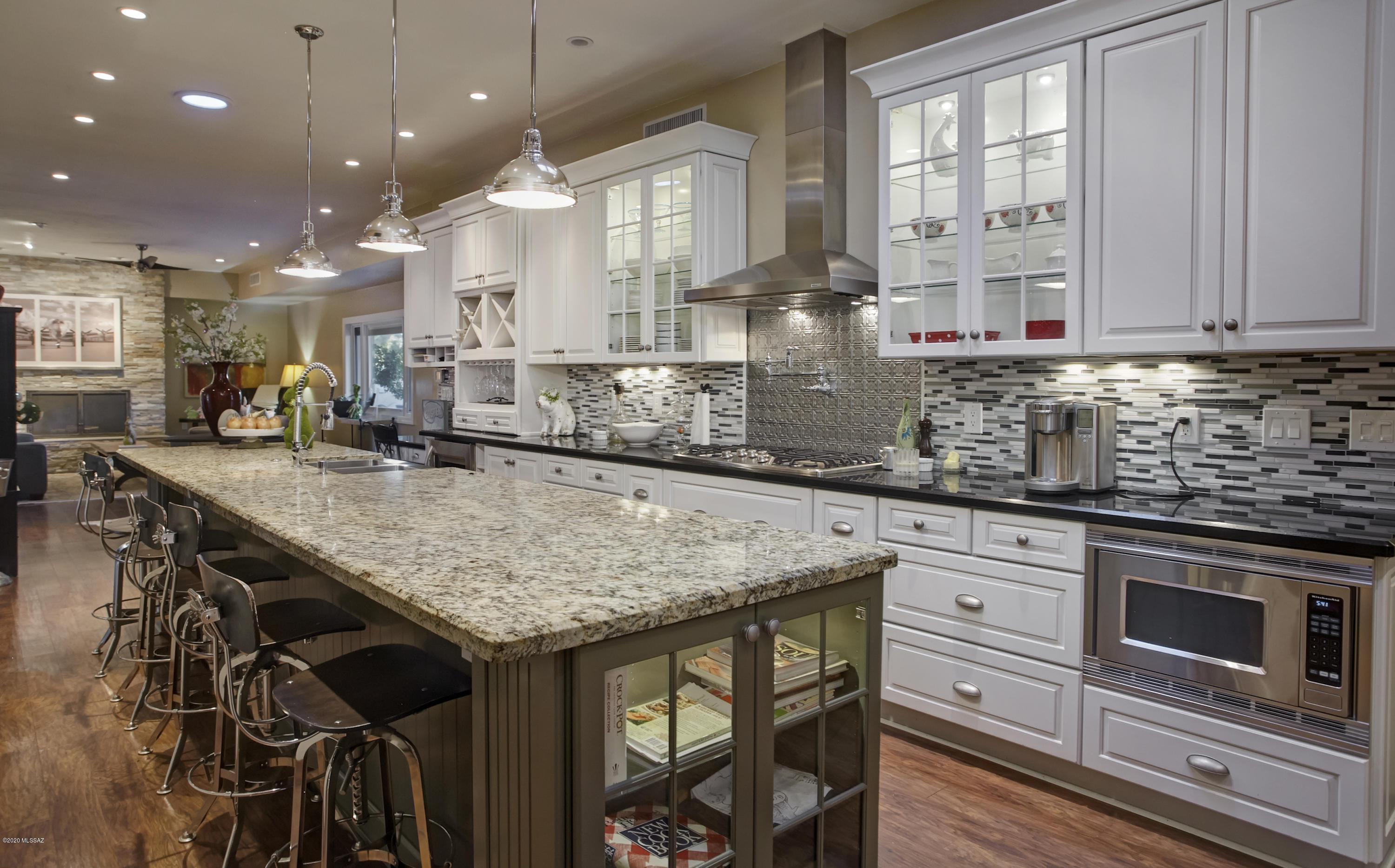 This exquisitely remodeled home in the heart of TCC estates boasts an over-the-top-kitchen with granite cntrs, glass tile backsplash, 5-burner cooktop, huge double stainless steel sink, wine fridge, soft closed custom cabinets & gorgeous wood floors. The fabulous Master Suite with office-sitting room, fireplace, customized closet, double sinks, designer tile shower & French doors leading out to the amazing backyard w/pool, 2 firepits, ramada & huge covered patio will surely please the most discriminating buyer. Other features to admire are split floorplan, rich solid wood doors, extremely cool  den/rec room, oversized garage and knowing these sellers spared no expense in all these amazing upgrades.