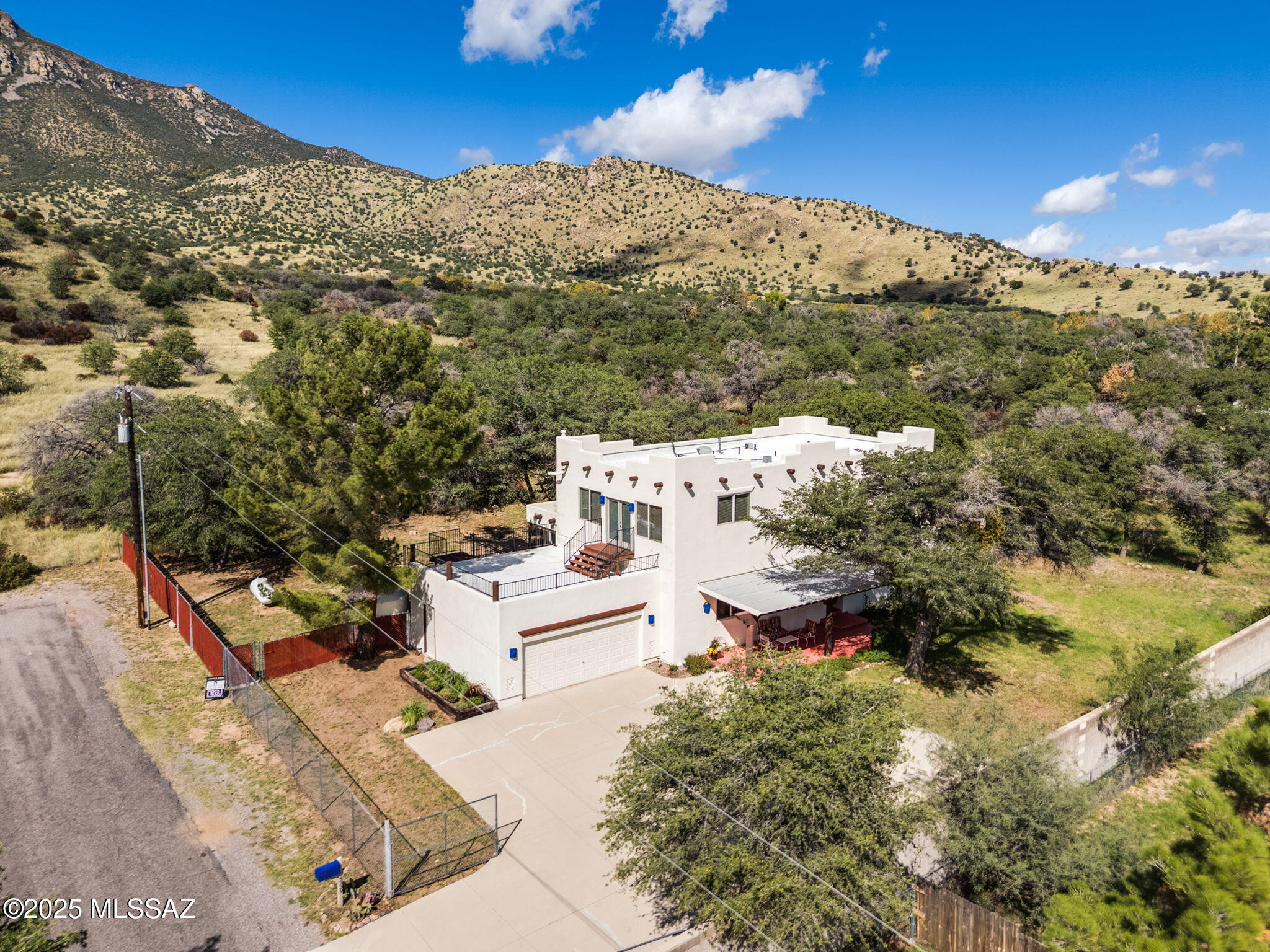 Bordering the Coronado National Forest, this 4-bedroom, 3.5-bath home offers space, versatility, and breathtaking natural surroundings. Nestled along the eastern boundary of the forest and framed by majestic oak trees, you'll enjoy immediate access to trails. The flexible floor plan includes a second-floor suite option with a separate exterior entrance, ideal for guest quarters, multi-generational living, or income potential as a rental or Airbnb. A large covered patio invites year-round enjoyment of the fresh mountain air, while the fully fenced yard provides privacy and room for pets or gardening. Whether you're seeking a peaceful retreat, a smart investment, or a home that can grow with your family, this property is the perfect blend of comfort, function, and nature's beauty.