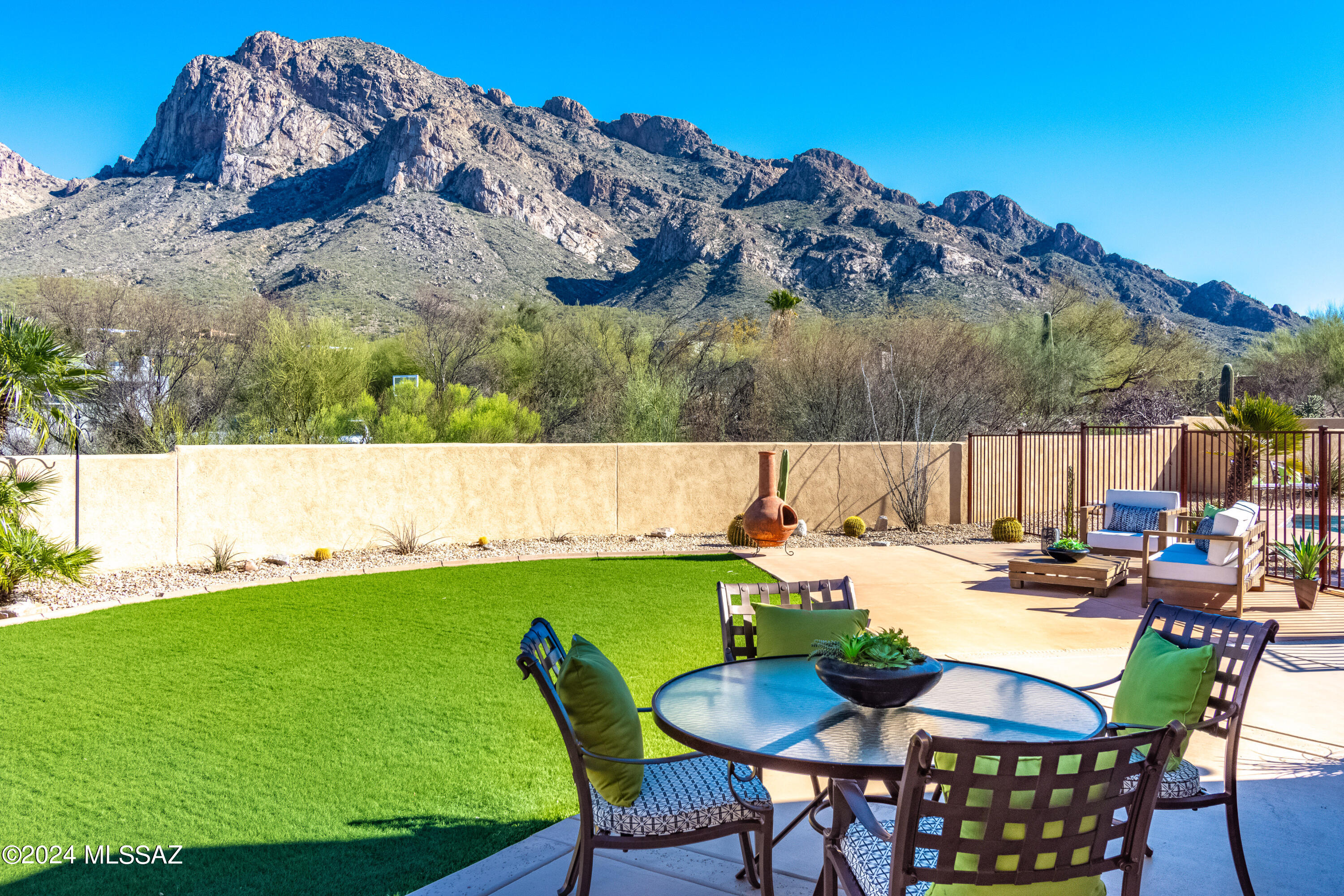 Views-Yep this one has them!! Amazingly up-dated to capture every possible angle of the Catalinas up close and personal. Tennis and golfer's delight...walk to the Oro Valley Pusch Ridge site. Open floor plan with very tastefully done kitchen-yes views, open family/great room-with more views. Easy care backyard and beautiful pool with the best views! Lot has room to add more garage or living space. Current garage is 2 plus for storage or workshop space. Charming front patio. This close in Oro Valley location can access schools, shopping, parks and the Oro Valley portion of the loop in minutes.