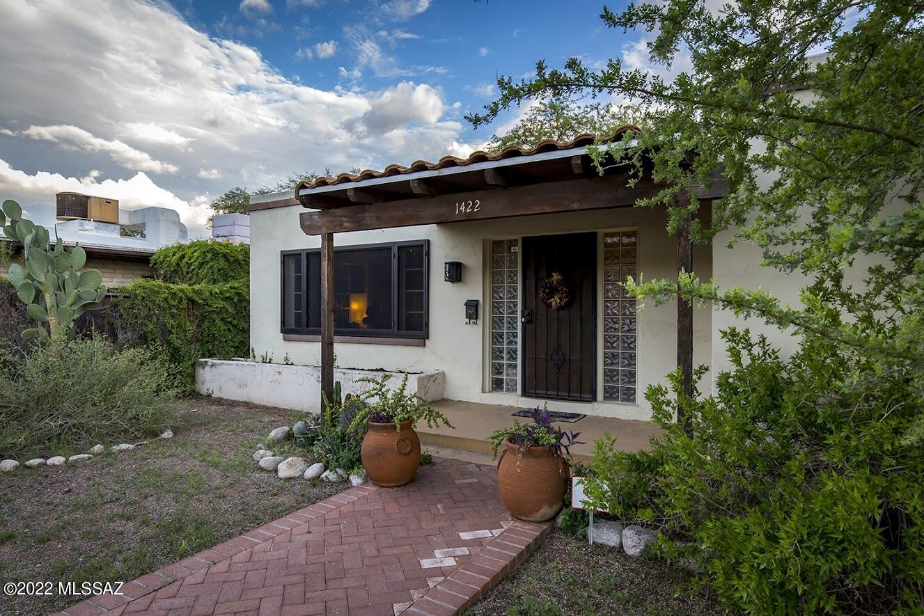 Vintage beauty, red brick home located close to UA, Banner, and downtown!  Gorgeous updates include alder cabinetry and built-ins, beautiful northern exposure and light. Cedar-lined custom closets and remodeled bath and kitchen, concrete countertops.  This is the home you enter and want to stay. Large shady patio in back, storage shed.  Lush cactus and mature trees in front, custom screens for privacy, security and shade, and the back is ready for your gardening touches.  Or develop the backyard further, with room to park off-street,  build a garage and/or ADU... wonderful alley access.  The Campbell Corridor is blocks away with great cafes, coffee shoppes, and the Mountain Ave bike corridor is a straight shot to UA.
