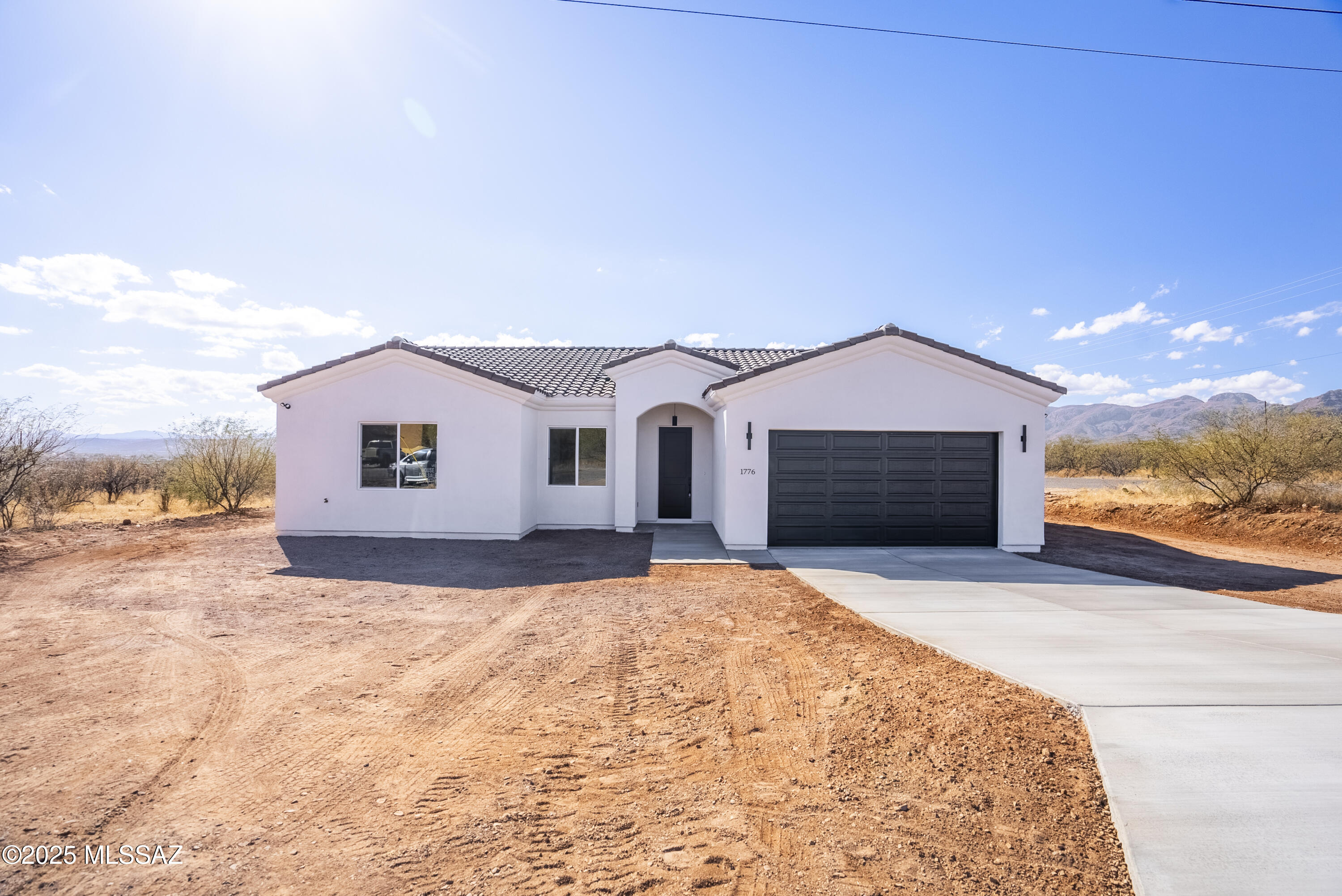 Stunning new residence available for purchase
on the Northeastern side of Rio Rico.
Enjoy breathtaking Mountain View's from this corner property. Three bedrooms, two bathrooms, and a two-car garage.
Approx. 1580 sq ft. living area underground electrical infrastructure, Quartz countertops stainless steel appliances 18x18 porcelain tile 10' ceilings 8' doors Alder wood custom cabinets. Extended rear patio, tile roof, Low-E 
vinyl windows A/C heat pump, Oversize Garage, water softner loop, All- electric