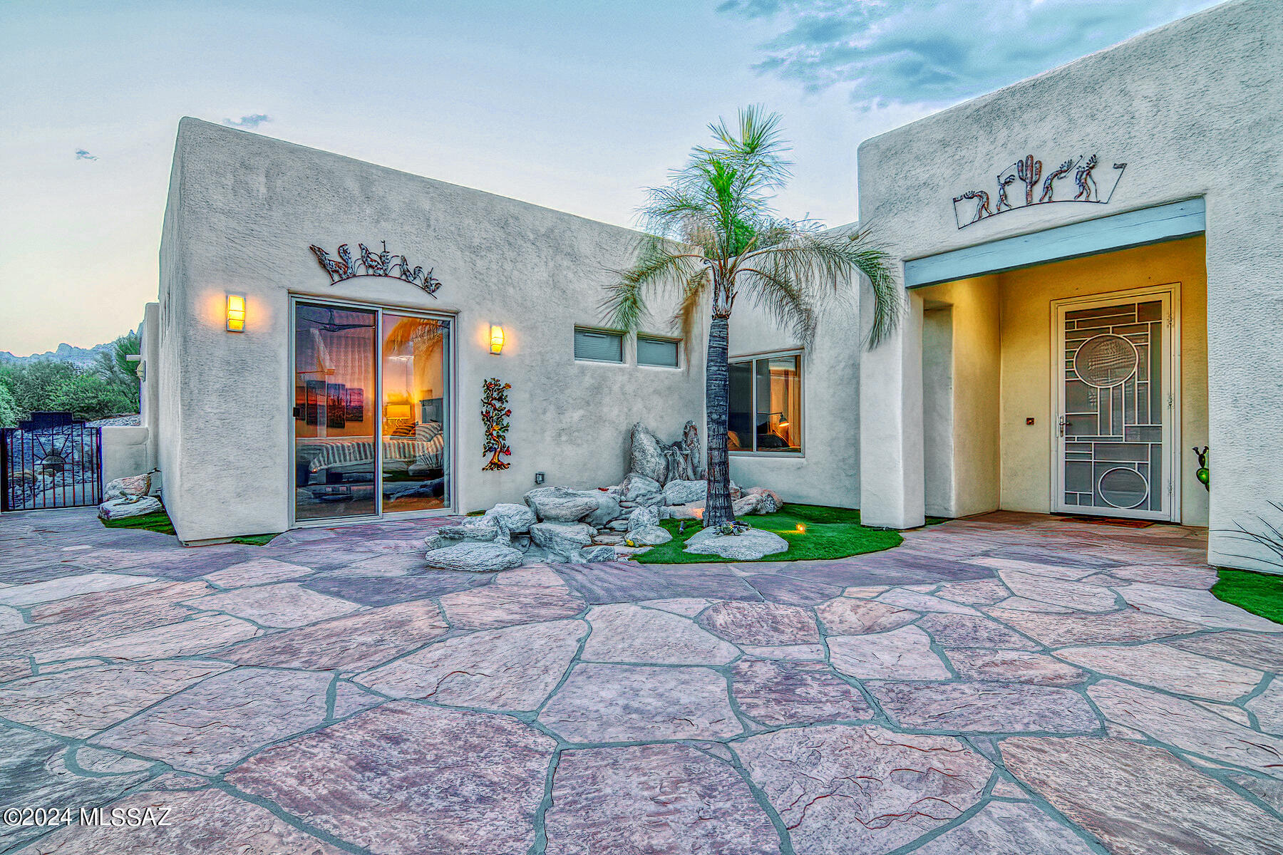 Situated on an elevated hilltop 1.05 lot, this dramatic 3 bed, 3 bath in Oro Valley is not your run of the mill property! Boasting Catalina and Tortolita Mountain views, the oasis like outdoor space is completely walled in & features massive sun sails, sparkling pool, separate gorgeous water feature & beehive fireplace with built in banco seating. Inside shows pride of ownership- it's immaculate & offers 20 inch imported Italian tile throughout in neutral tones. Stylish open kitchen has quartz counters & chic backsplash that matches the fireplace in the adjacent family room.Posh remodeled full bath services guests. Coffered ceilings in large open living space, split bedroom floorplan for added privacy.  Two primary suites with access to outdoor patio space. Hilltop lot with long driveway.