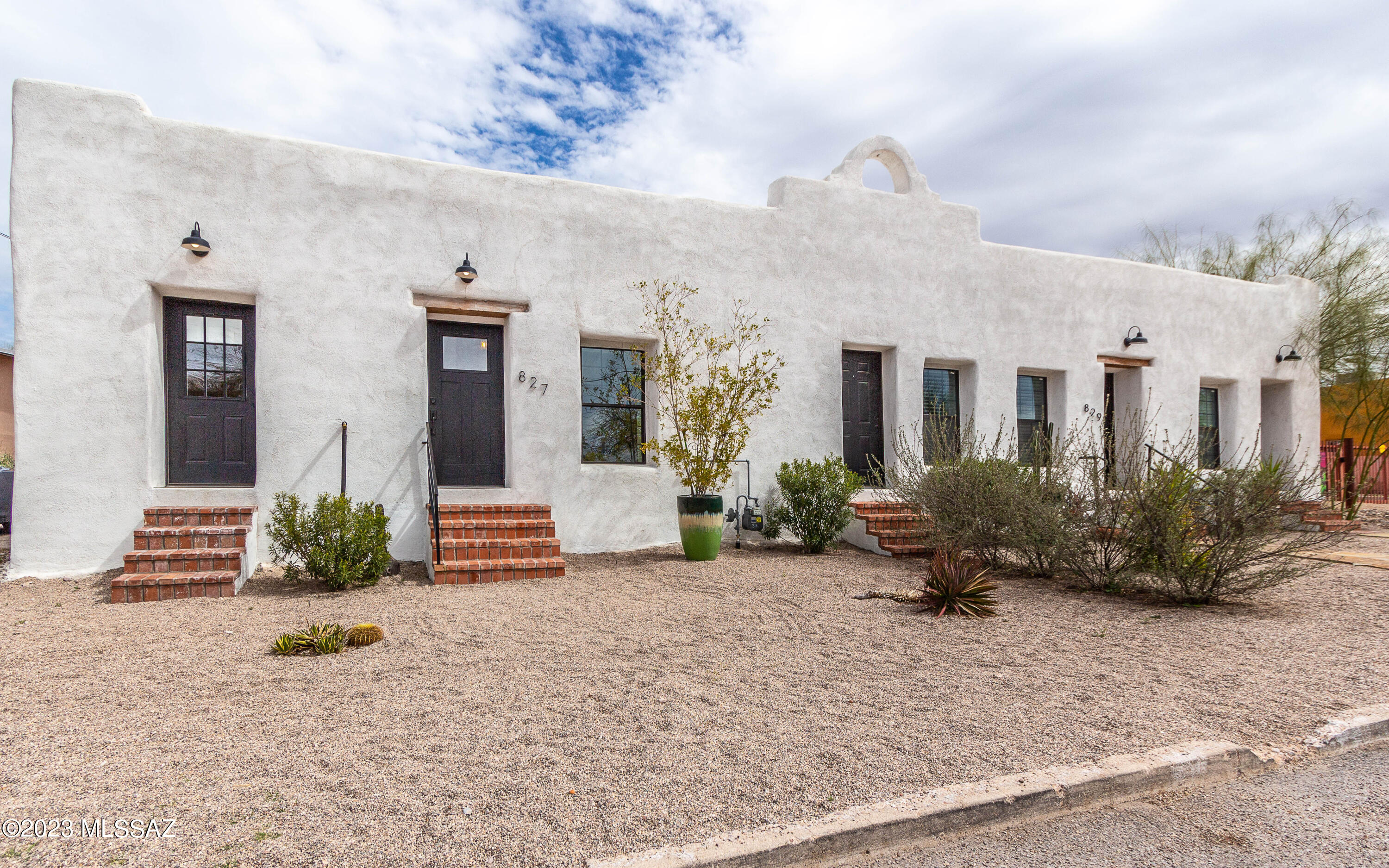Beautifully restored historic Sonoran row house in Barrio Santa Rosa. Originally built in the late 19th-century, this home has been thoughtfully renovated to preserve its historic adobe charm while offering modern amenities. The huge kitchen has lots of counter space, a 5-burner gas cooktop, conv oven, walk-in pantry, lots of drawers & a big island. It's perfect for entertaining. The focal point in the primary suite is the rustic adobe. The room is spacious enough to include a sitting area, a walk-in closet, and a beautiful modern bathroom. Another bedroom has a separate entry. There's a big backyard & a 2-car garage, which is seldom found in the area. Located in the heart of Tucson's barrio, just steps away from the 5 Points area with lots of local restaurants and walkable to downtown.