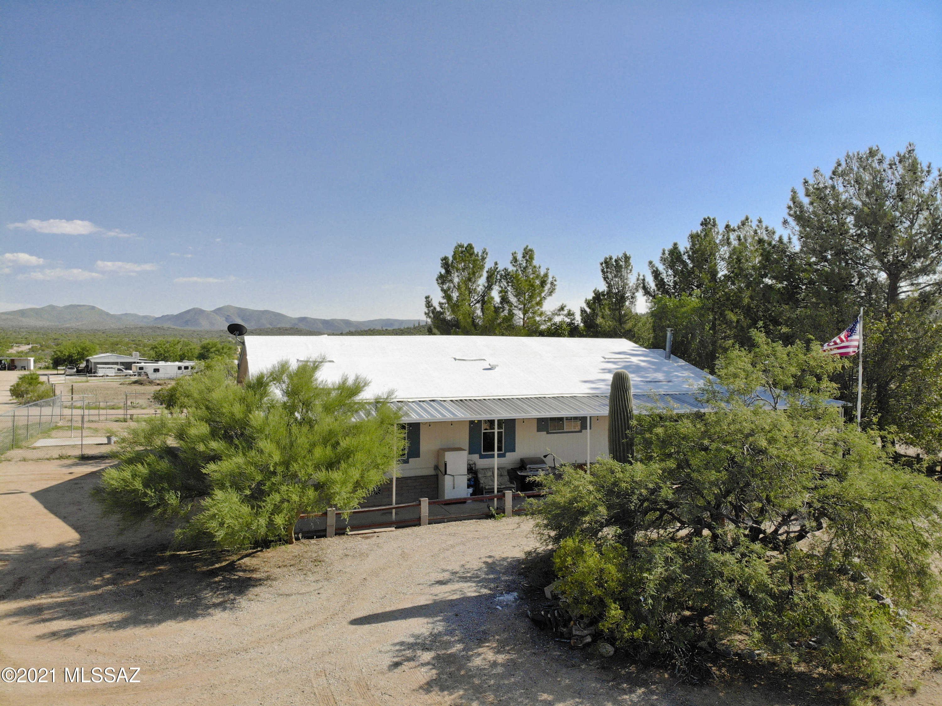 View this amazing 8 acre ranch house property! It's a former model manufactured home using 2x6 construction, upgraded insulation, and a great floor plan w/den off large primary bedroom. Complete with a wood burning stove, updated windows, gutters, 2 year old septic, newer well, dog run, and vegetable garden. Property amenities include a workshop, tuff shed, hay burn, tack room, over two acres of horse corral, full slab cement foundation, quiet gas pac outside, recently recoated roof, propane hookup for BBQ on front porch, full water (on float) and electric to pens, electric gated entrance, and mature tall trees. Room for expansion too! Plenty of usable space and well designed drives to avoid backing up trailers. Must sell with adjoining 2 acre listing. No HOA! View the 3D Walkthrough Tour.