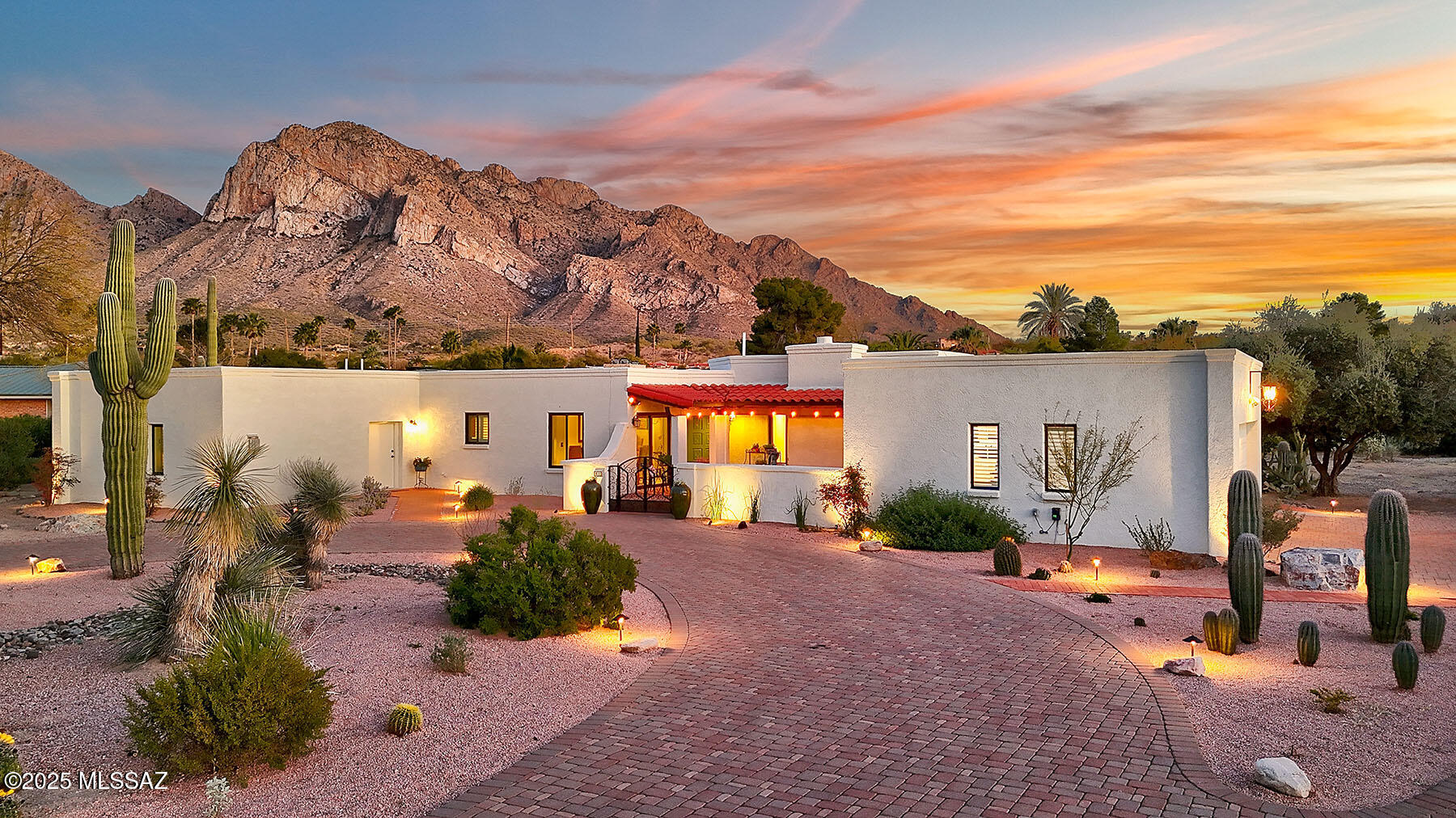 Nestled in the prestigious Oro Valley Country Club Community, this gorgeous Southwest-style home offers breathtaking mountain views on an incredible lot. Just moments from the Oro Valley Country Club—where members can enjoy golf, dining, fitness, and pickleball—this home combines luxury with an unbeatable location. A paver driveway and gated courtyard welcome you into a beautifully remodeled interior, featuring new tile flooring, doors, lighting, and windows. The stunning kitchen boasts rich Alder cabinets, granite countertops, and stainless steel appliances, complemented by a newly designed butler's pantry with a dedicated coffee and wine area. A spacious flex room provides endless possibilities for living and entertaining, enhanced by a recently added fireplace, custom entertainment center and a third bathroom. The living room's focal point is a striking fireplace, framed by custom mosaic tiles and a newly crafted mantel. Retreat to the expansive primary suite, complete with a spa-like bath and a generous walk-in closet. Step outside to a backyard oasis, where you'll love entertaining under the large ramada, taking a refreshing splash in the heated pool, and soaking in the stunning desert landscape with yard lighting and panoramic Catalina Mountain views. Additional upgrades include HVAC units, fresh interior and exterior paint, a custom mailbox, a new water heater, and a natural gas connection. This remarkable home is a true Southwest gem!