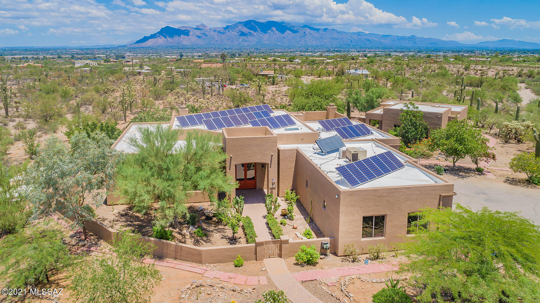 Spectacular City & Mtn views abound from this stunning Hacienda Estate. Top-of-the line finishes & products are found throughout. Soaring ceilings, walls of windows, glass doors & large open living spaces throughout. Arched entries & custom Alder doors, cabinetry & built-ins add to the character & charm. Beautiful Travertine floors are found throughout. The huge center island kitchen offers all the bells & whistles -- professional grade S.S Viking Appliances to include 6 burner gas cooktop w/griddle, double ovens, refrigerator/freezer & wine frig. Chiseled edge granite counters are gorgeous. 3 fireplaces are focal points in the great room, master suite & oversized shady veranda. Resort-style yard featuring a fully enclosed lagoon-style pebble tec pool & spa. 2 bedroom guest house w/kitchen
