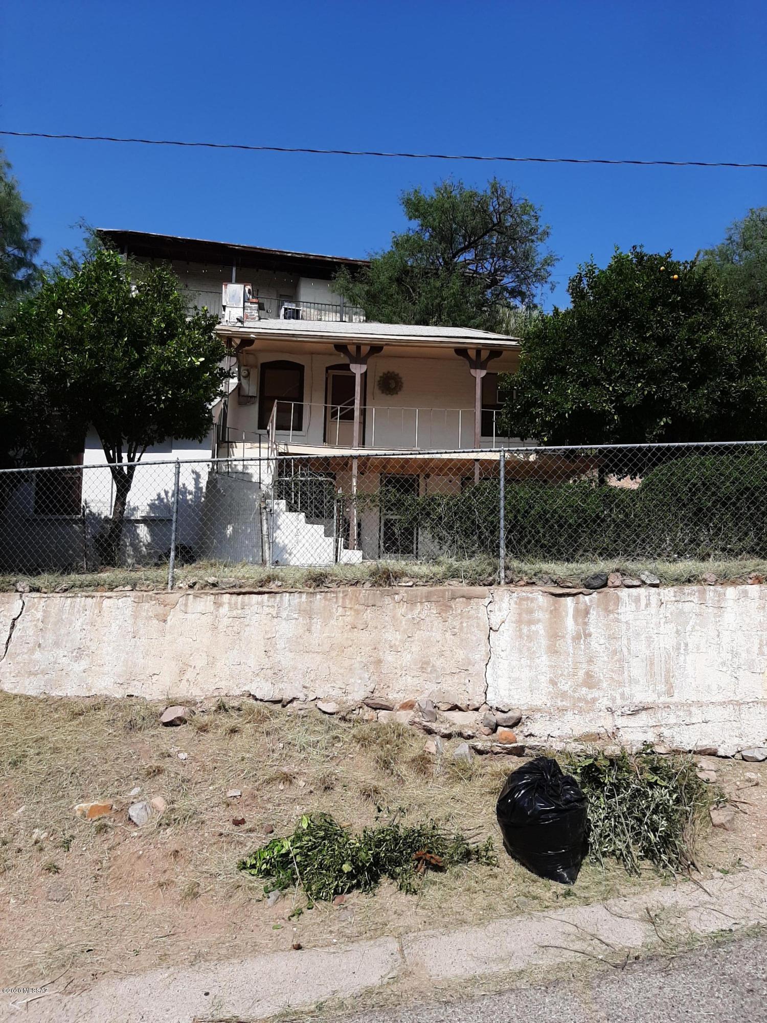 Great investment opportunity! Needs some TLC, but has lots of potential! Downstairs unit is 1 bed room 1 bath, with kitchen, dinning area and living room. Upstairs is 1 bed room 1 bath, large kitchen area. both units have covered porches. Very private in the heart of downtown Nogales. Live in one unit and rent the other to pay for mortgage, fix and flip or purchase for rental income. Rental for 10 years, each unit rents for $450 a month. Highly motivated seller!