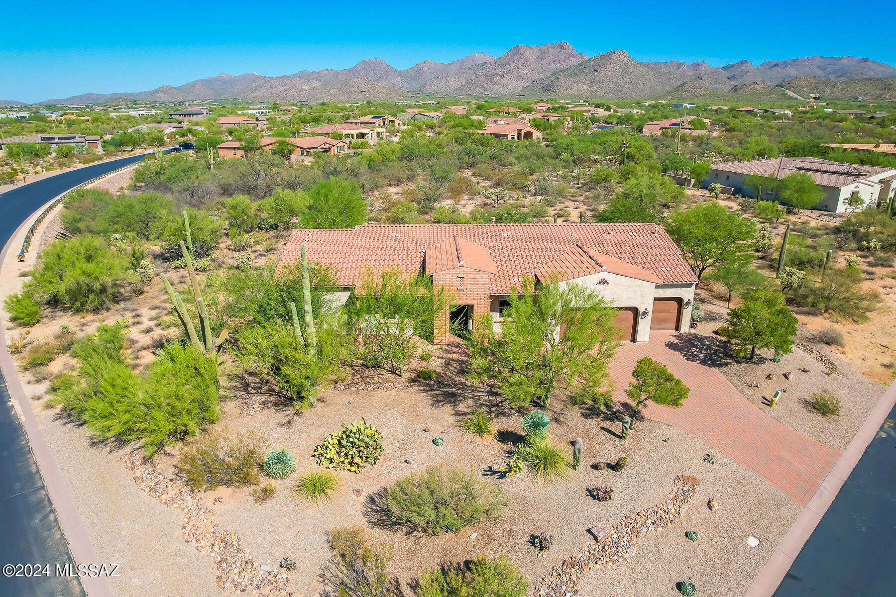 Exceptional 3,138sf Kimball model in gated Tortolita Vistas affords a spectacular Tortolita Mountain backdrop plus Catalina views to the East. This idyllic home offers 3 ensuite bedrooms, open concept great room with fireplace and formal dining room for entertaining, plus den/office with French doors. Welcoming corner lot home situated on .73 acres greets you with a brick paver drive, stacked brick entry, rustic iron garage doors and wrought iron, screened entry door. Thoughtful amenities include wired sound in main living areas, overheight ceilings and doors, plus granite countertops throughout. Elegant Owner's suite with recessed ceiling hosts a spa-like bath with dual sink vanity, relaxing 'air bubble' tub, tiled walk-in shower and walkthrough closet accessing laundry and powder room. Striking gourmet kitchen hosts a suite of GE Profile stainless appliances including double ovens/microwave/gas cooktop, a walk-in pantry, plus dining nook with views and large center island with breakfast bar. Additional amenities include extended 3-car garage, fire suppression and security alarm. Retreat to a serene rear patio and yard with extended brick pavers, raised planters, water feature, view fencing, mature desert landscaping, plus 4 rolling sunscreens that fully enclose the patio. A true desert retreat for the most discerning buyer!