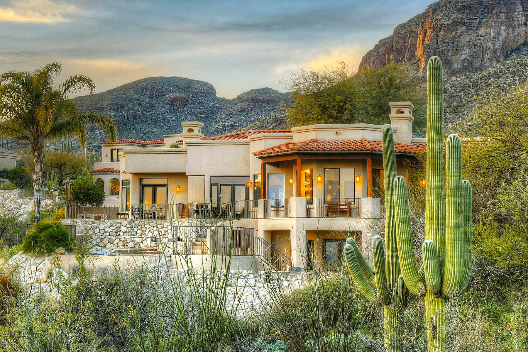Outstanding Kevin Howard designed southwestern contemporary high above they city in gated Summit at Finger Rock (which backs up to the Coronado National Forest) with sweeping Tucson valley, Santa Rita and city views.  Enter into the living room of this 4 bedroom, 3,541 sq. ft. home with soaring ceilings, hand painted arches, walls of windows, see forever views and 24'' X 24'' travertine tile floors.  Kitchen offers cherry cabinets, granite counters, stainless steel appliances, gas cooktop and adjacent family room with fireplace.  Gracious master suite features fireplace, master bath with granite counters, spa tub, dual vanities and walk-in closet.  Activity room has wet bar and walk-out to rear yard with pool, spa, walkways, sitting areas and did we say views, views and more views!