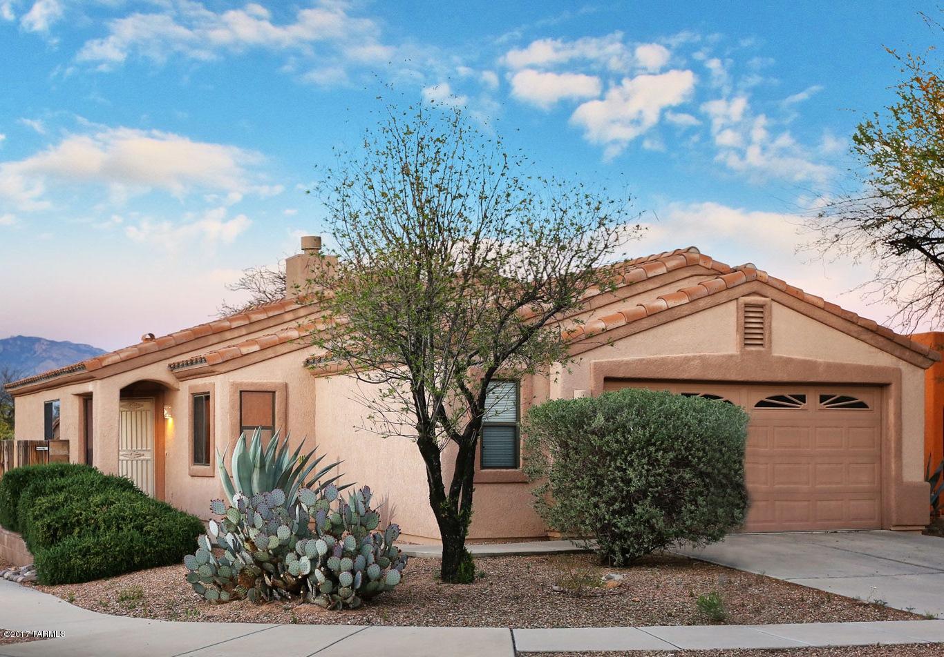 Best kept secret on the west side! Star gazing at its finest! Private & quiet oasis. Gated community with beauty & nature. This wonderful home is set high on a lot! Catalina Mountain view, from the backyard! The inside is amazing offering, granite counters in the kitchen. Newly tiled master with rain shower and glass doors! New A/C, furnace & thermostat. Windows have special tint to keep the Sun out without being to dark! New Security screen door. 20' porcelain tile in the kitchen. Stainless steel gas stove and dishwasher. Plus a community pool just a short distance away! You must see it today!