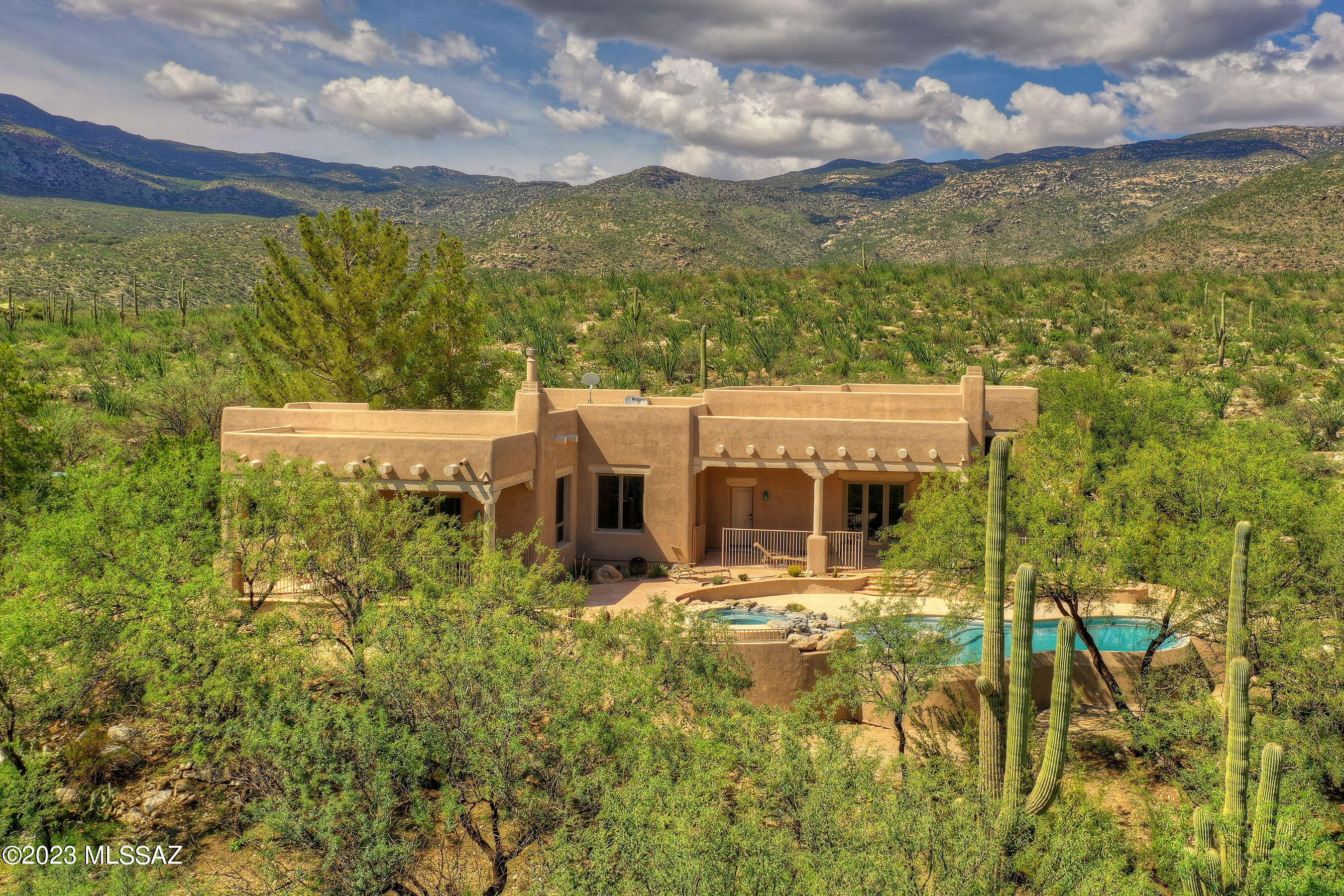 A running river... 45 + acres...This home literally borders Saguaro Nat'l Park, yet only 45 min to downtown Tucson & Airport. Where else does the AZ desert meet water in such a pristine riparian environment? This stunning 3,709 sf SW style ranchette is set within exclusive manned-gated X9 Ranch (36 ac min lot size) Biodiversity nature at your doorstep. This unique home is surrounded by all AZ wildlife, majestic saguaros, Rincon Mtns & stunning lush, high desert flora. Walk to outdoor living – a boating area on your OWN creek, scenic trails, bird watching, cycling, horseback & hiking. At 3,300 ft, temps are cooler. Authentic SW style inside & out - Infinity edge pool/spa. Open 4 bed/3 bath – no steps, large windows with VIEWS, soaring viga ceilings/beams. Horse/livestock allowed