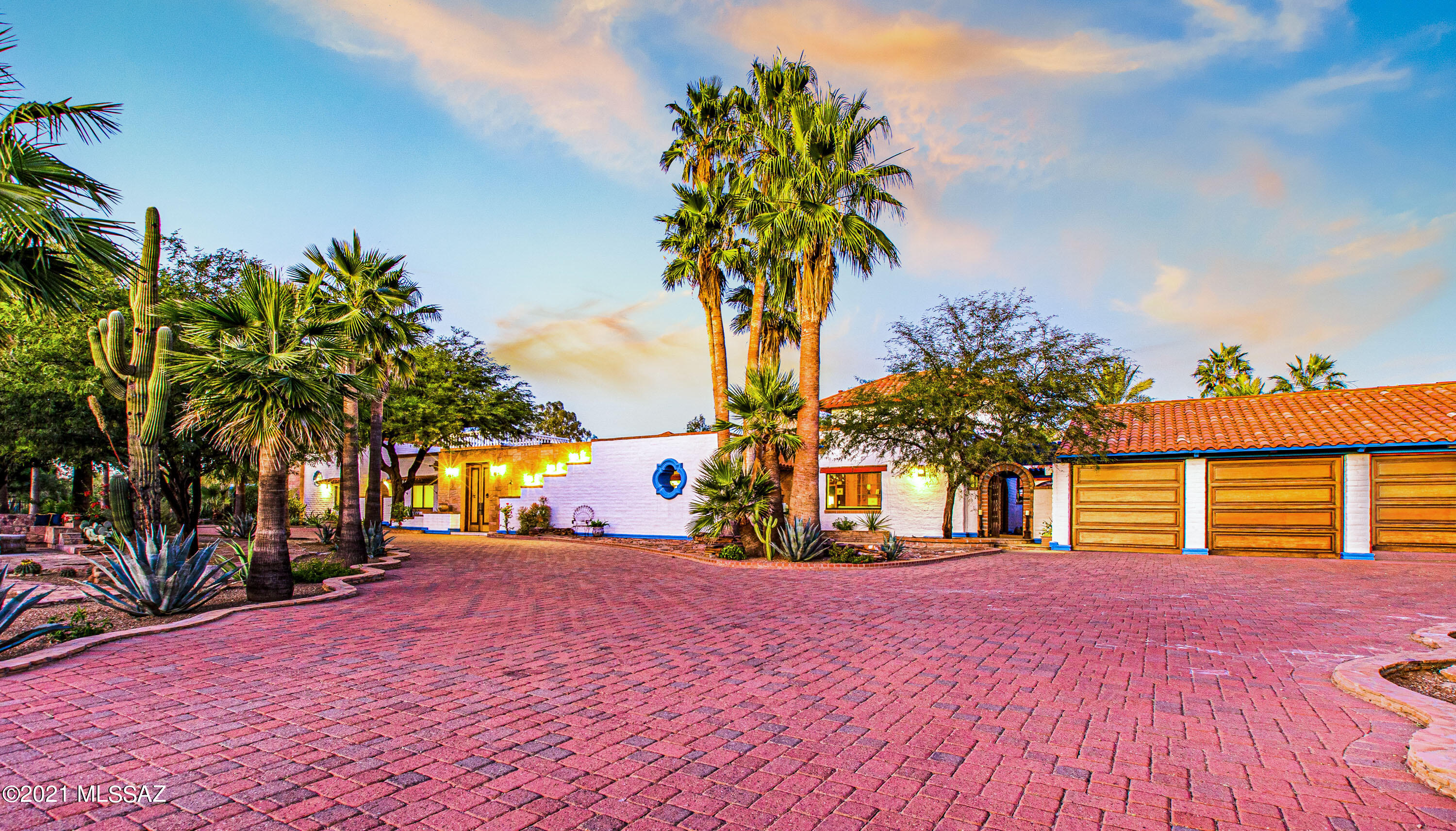 CHECK OUT THE VIDEO! This one-of-a kind property allows you the opportunity to purchase your own private resort. This luxurious 6 bedroom, 8 bath home offers a gourmet kitchen with 36'' Viking stove, Viking dishwasher, quartz countertops, large island with prep sink, and a subzero fridge. The spacious primary suite features a beautiful library with custom mesquite built-in bookshelves, two primary bathrooms with large soaking tub, 2 walk-in showers, gorgeous quartz countertops and a Swedish spa room with sauna. You'll fall in love with the custom mesquite wood finishes throughout the home and beautiful exposed wood beam ceilings. This property is an entertainers dream with a fully equipped outdoor kitchen with a rotisserie, smoker and grill, large salt water heated pool with large lagoon fountains, water features throughout the property, and a large, covered patio and Ramada for outdoor living. Other unique features include a roof top viewing deck where you can experience incredible mountain, city and sunset views, an aviary for exotic birds, UofA Basketball court and an indoor racquetball court. The spacious 763sqft guesthouse is fully updated guesthouse with a wood burning fireplace, a separate bedroom and bathroom with a private patio. You will never find another home in the Old Pueblo like it. Come make this beautiful property, your new home.