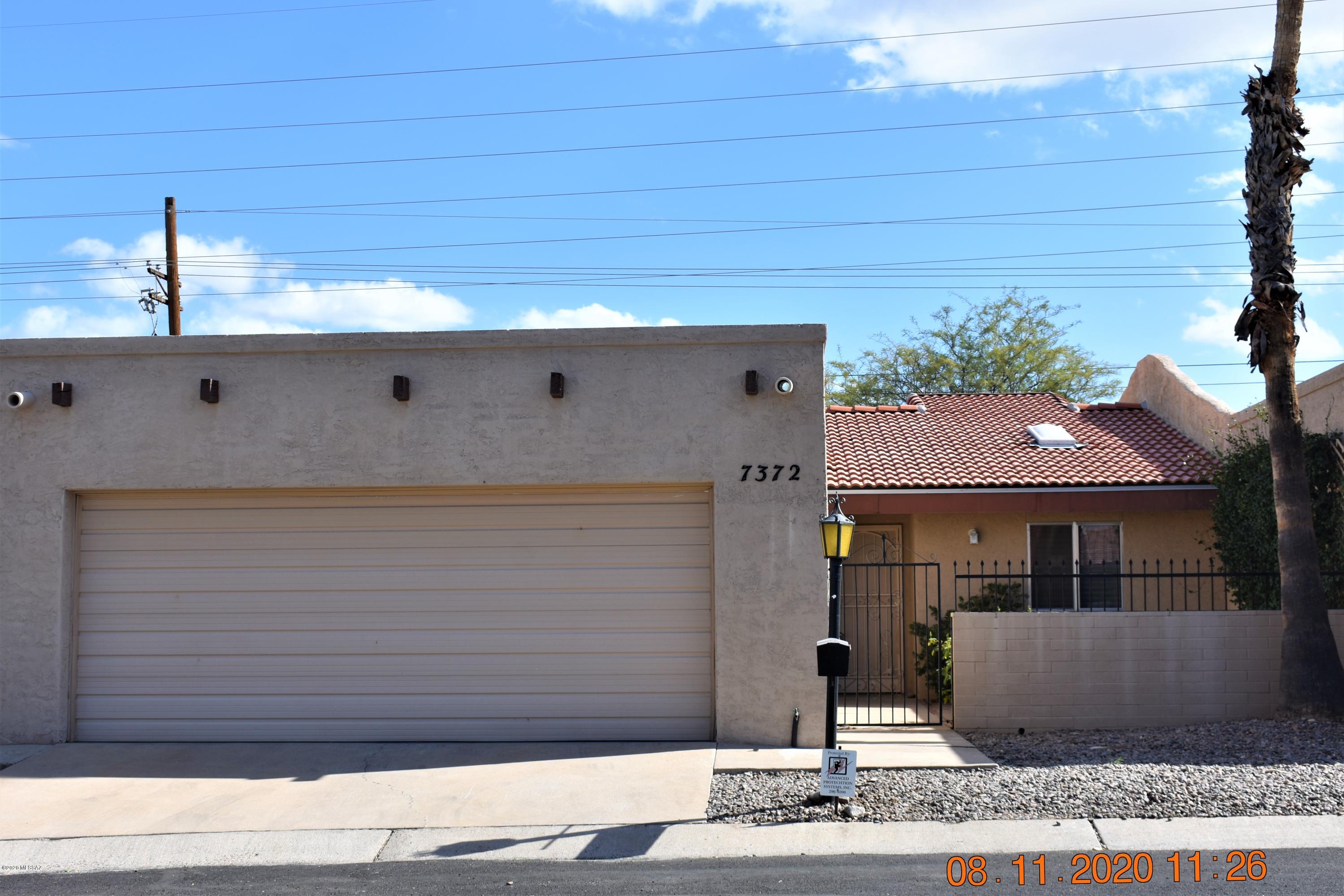 A MUST SEE! Move in ready town home in the quiet desirable Las Quintas neighborhood. 4 bedrooms w/2 baths.  Nice flowing Open floor plan with soaring vaulted ceilings throughout parts of home. Attractive fireplace in roomy living room, large kitchen with stainless steel refrigerator, electric stove, and microwave. Low care landscaping in front and backyard with gated Front Courtyard. Large 2 car Garage with LOTS of storage. Rolling shutters installed along bedroom windows on North side of home. Brand new roof. Short walk to Community Pool.  Fantastic location, close to everything, Shopping, Medical and great Restaurants.