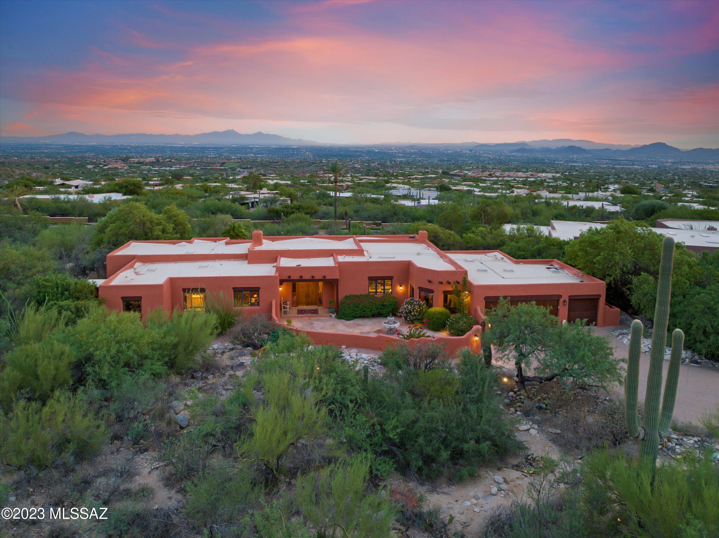 The home is back on the market as the previous buyer had a change of heart. Inspections have been conducted and the home is in pristine condition. This presents a perfect opportunity to buy with confidence, as the home has undergone thouough inspections, ensuring its excellent condition for prospetive buyers. Welcome to the prestigious Catalina Ridge Estates in the luxurious gated Cobblestone community. This exquisite property boasts luxury living at its finest, with four spacious bedrooms, and four beautifully appointed bathrooms, all situated on just under an acre of stunning desert landscape. This home is the epitome of elegance with Santos Mahogany wood flooring, Typhoon Bordeaux granite countertops in the kitchen w/ exaggerated 12' center island, designer appliances, custom 117 wine wall by Lost Barrio and a breakfast nook with the most gorgeous mountain view- see the features and upgrades list! Interior offers a seamless blend of contemporary design and timeless sophistication. The roomy floor plan seamlessly connects the living spaces, creating an inviting atmosphere for both relaxation and entertainment. You'll never want to leave this backyard with the breathtaking infinity pool and spa with stunning water feature which is fully automated by remote operation! This gorgeous landscaping creates an ideal setting to bask in the Arizona sun while enjoying panoramic views of city lights and majestic mountains. Whether you're hosting gatherings or seeking a private retreat, this outdoor oasis is sure to impress. This is a rare opportunity to own a piece of desert paradise in an exclusive community! Experience the ultimate in luxury living where every detail has been meticulously crafted to provide a lifestyle of unparalleled comfort and sophistication!
