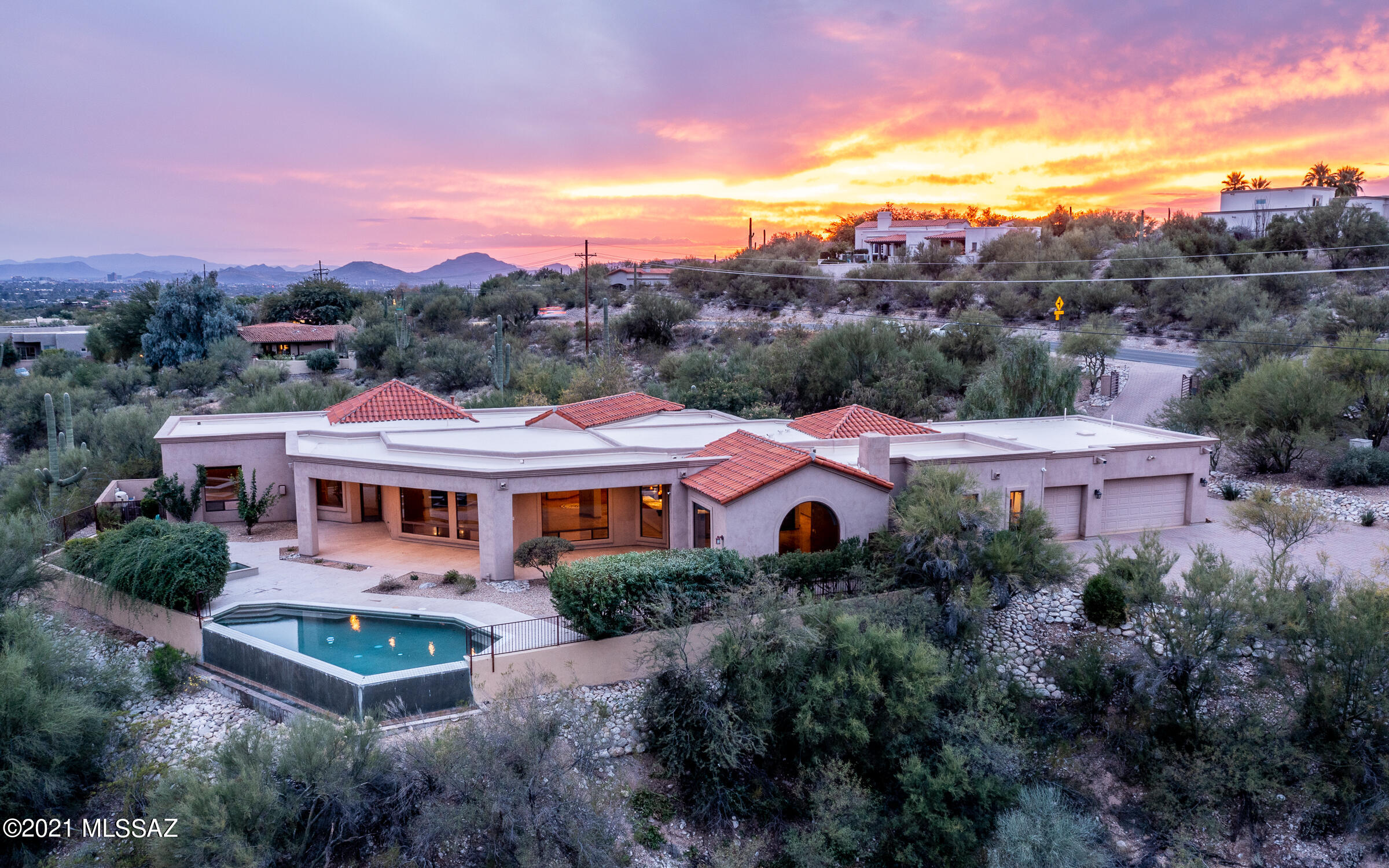 Beautiful Views & Prime Location. Privately gated custom home on 2.08 acres in Catalina Foothills Estates 10. Spacious split floor plan, single level, no steps. Two ensuite bdrms, 4th bdrm can be media rm or den. Separate dining rm/office space. Guest quarters off the 3 car garage. All paver driveway with entrance and exit gates, fountain & gated courtyard. Solid metal/glass dbl entry doors lead into the foyer. Natural light & views flood the large living space w/ floor-to-ceiling windows.  Polished travertine flooring. Open kitchen w/ 6 burner range, 3 ovens, 2 refrigerators, 2 dishwashers, island & breakfast bar, wine fridge, granite counters, solid knotty Alder 8' doors & cabinetry/built ins. Outdoors enjoy a spacious Cantera patio overlooking infinity-edge pool, spa & panoramic views.