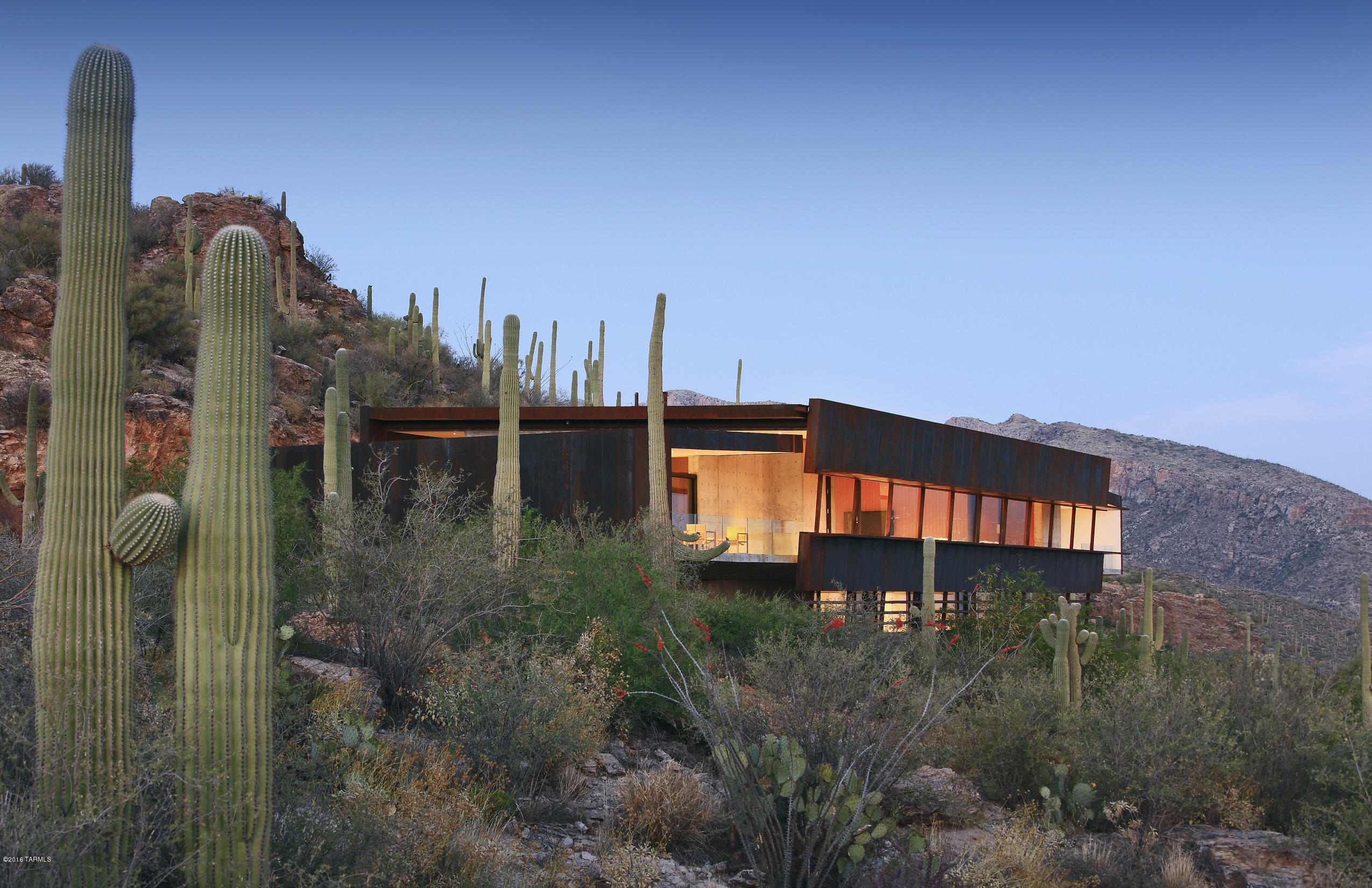 DESIGNED BY AWARD WINNING ARCHITECT RICK JOY & ONLY HOME OF HIS THAT IS CURRENTLY FOR SALE. INTERNATIONALLY ACCLAIMED HOME FEATURED IN NATIONAL BLDG MUSEUM EXHIBIT IN WASH D.C. BREATHTAKING TOP OF THE WORLD CITY/MTN VIEWS FROM EVERY RM OF THIS PURE CONTEMPORARY HOME ON 3.5 ACRE HOMESITE IN PRESTIGIOUS GATED VENTANA CANYON MTN EST,THIS EXCEPTIONAL HOME IS A DESIGN MASTERPIECE OF STEEL/CANTILEVERED CONCRETE YET HAS THE WARMTH CREATED BY BLACK WALNUT WOOD THRU OUT,EXQUISITE LIVING RM/DINING RM W/INDOOR/OUTDOOR AMBIANCE FEATURING WALLS OF WINDOWS,ELEGANT FIREPLACE,GOURMET KIT W/LOVELY BRKFST AREA,ELEVATOR,4 BDRS+GUEST QTRS,6 BATHS, MSTR BDR,AMAZING SHOWER,FAB CLOSETS. GRACIOUS OUTDOOR LIVING W/INCREDIBLE POOL,CASCADING WATERFALL,DRAMATIC FIRE BOWL,OUTDOOR KIT,VIEWS!DRONE VIDEO UNDER PHOTOS.