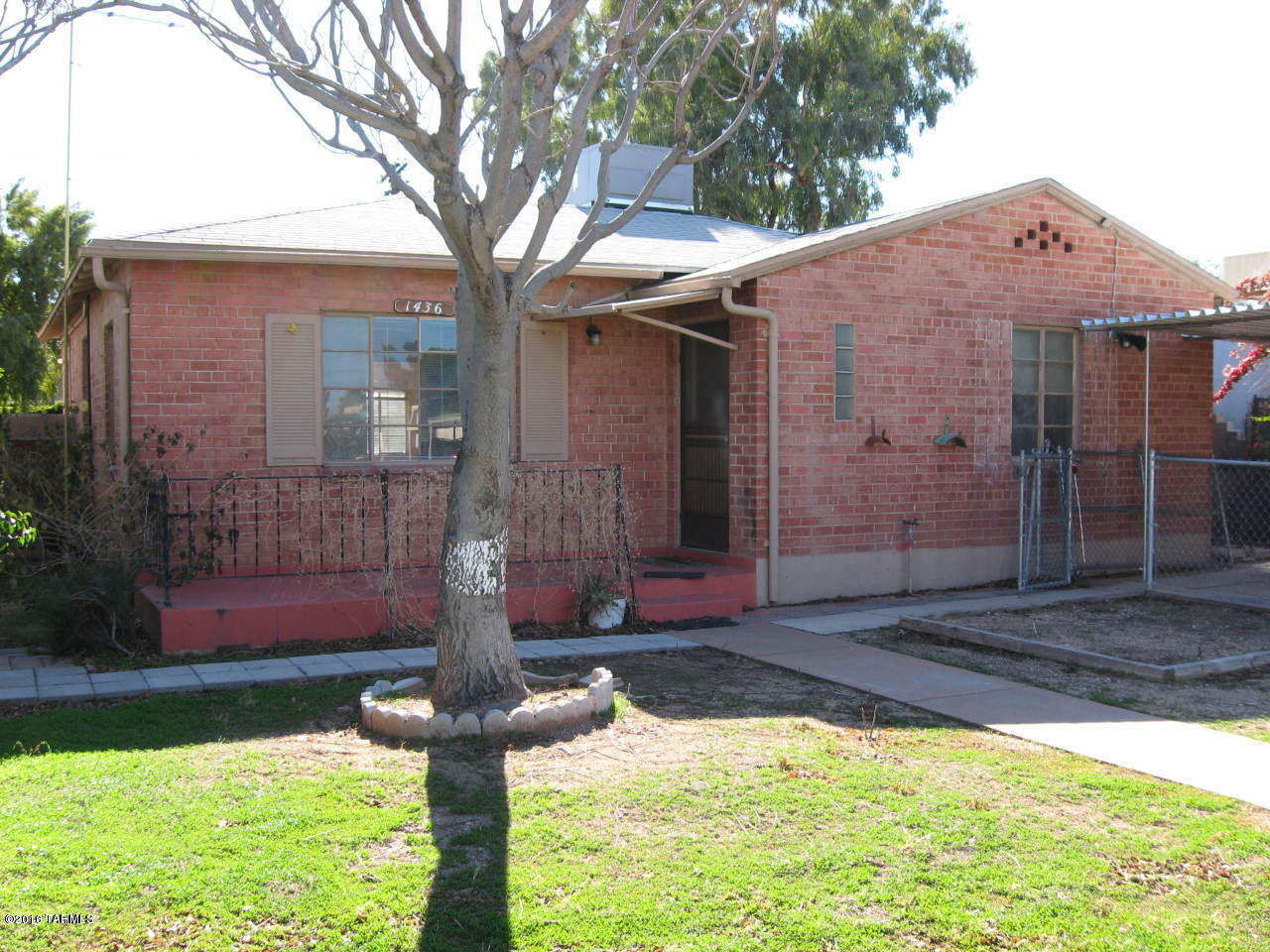 The yard work is included on this red brick 3 bedroom 1 bath home. Updated kitchen with new cupboards, counters, range & microwave. Big back yard with off street parking. Tile and concrete floors. Location near U of A and UMC Banner. Washer and dryer are included.  Call Kat 520-245-4002.