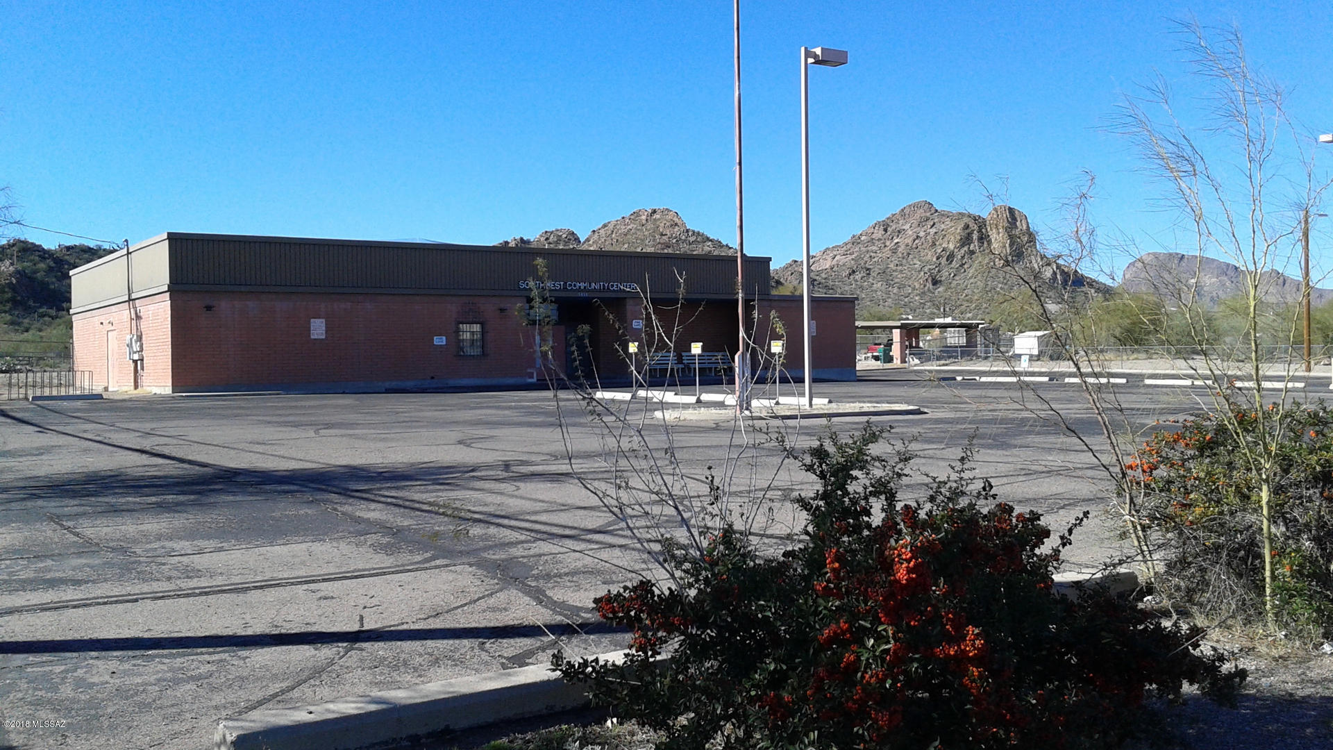 4755 SQ/FT COMMUNITY MEETING CENTER ON LARGE 2.07 ACRE LOT.  INCLUDES APPROX. 1400 SQ/FT OF RAMADA SOCIAL AREA, ADDITIONAL EXTERIOR BATHROOMS & 2-STORAGE SHEDS.  8' X 20' STORAGE CONTAINER (NEGOTIABLE).  INTERIOR INCLUDES RECEPTION AREA, OFFICES, LARGE MEETING ROOM, STORAGE AND SMALL COMMERCIAL KITCHEN.  KITCHEN INCLUDES PREP AREA, VENTILATION HOOD AND ANSUL FIRE SUPRESSION SYSTEM AND (WET) SPRINKLERS.  LIGHTED ROAD SIGNAGE.  AMPLE LIGHTED PARKING AND BASKETBALL COURT. CURRENTLY OCCUPIED BY A NON-PROFIT ENTITY.
