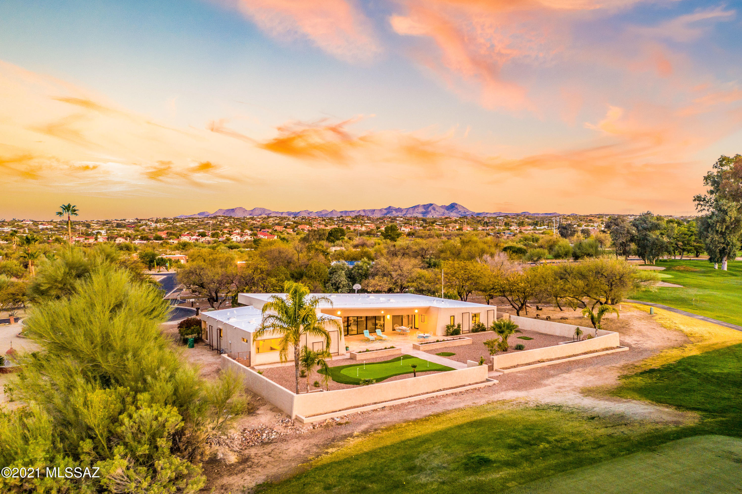 Unique mid-century modern home designed by Architect Nicholas Sakellar. Located on Oro Valley Country Club's 1st fairway with superb Catalina Mountain views, the expansive SE-facing patio offers privacy and serenity plus a putting green and room for a pool. Great room with beamed ceiling, wood floors, stone-faced fireplace and wall of windows offers sweeping golf and mountain views. Rec room provides separation for TV, music or reading. Sleek and bright kitchen includes luxury amenities and custom white cabinetry. Master suite has luxurious bath plus patio access. Split layout (4BD/4BA) includes guest suite with private access. Striking contemporary design, private cul-de-sac setting with golf course and panoramic views make this an impressive and uniquely special home! Open House 4/11!