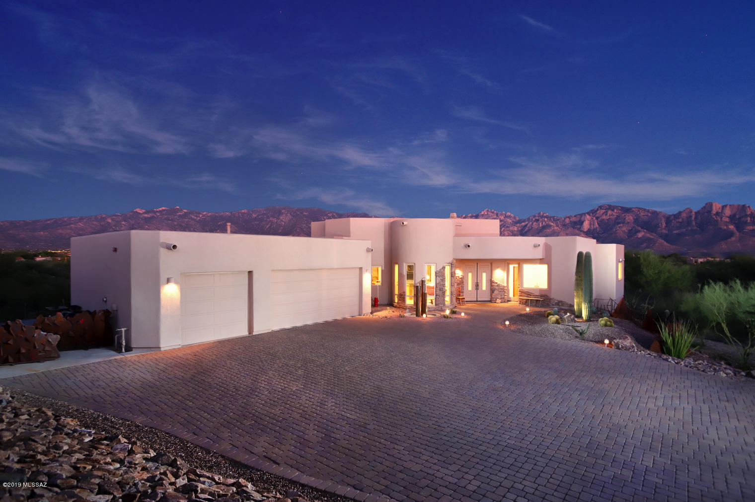 Wrap-around Catalina Mountain views from elevated lot bordering acres of natural desert! Stunning east-facing custom built by Mike Amli in The Estates at High Mesa. 4 bedroom 4 baths (3,035sqft) on over an acre with an extended 3 car garage atop the Estates at High Mesa. Modern open floor plan, tall ceilings and oversized windows with 10 year transferable warranty showcasing unobstructed mountain views. Spacious master suite with patio access, walk in closet, luxurious bath with jacuzzi style tub and custom slate tile shower with copper inserts. Open concept chef's kitchen with granite counter tops/back splash, curved island, SS appliances, hand made hickory cabinets & over sized pantry. Tile floor throughout -no carpet!-.
