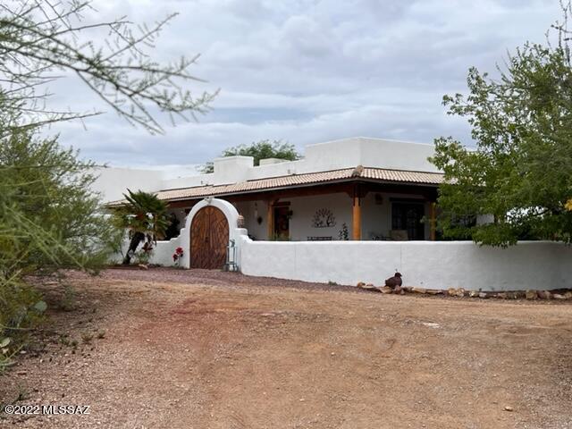 This beautiful Southwestern Santa Fe Home
With breath taking View's of mountains, sunrise, sunsets while relaxing in your pool.  Wrap around enclosed porch.  Luxurious vegetations and Fruit trees. Located in the middle of 4.Plus acres,(Fenced) . Additional  Room could be used for den, 4th bedroom, office, Has newly coated roof, A/C 3yrs Old.
This property has a building for workshop, shed or tack room.  Move in ready. Don't miss it.