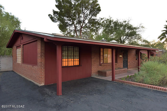 Beautiful, bright Mid Century modern home with a permitted addition that can be used for a playroom, rec room or whatever you can imagine! The back yard is spacious and shady with a covered porch.  The home has a North/South orientation with a mountain view from the front.  The main bathroom has been nicely updated.  Tile throughout.  New roof in 2016 and exterior painted in 2017.  There is also a large water harvesting vessel to use for watering the lush backyard.