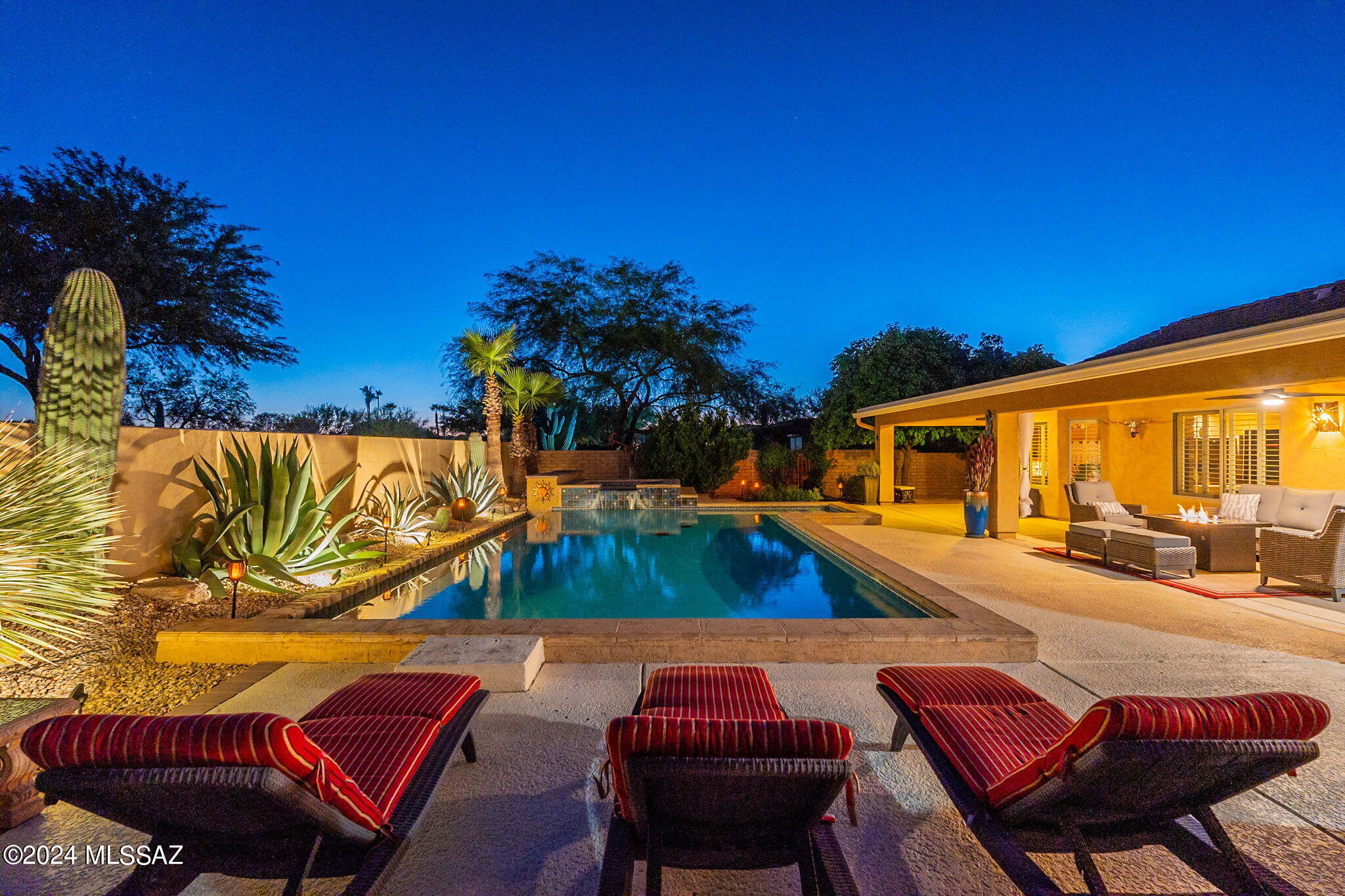 Stunning extended & updated three bedroom Laredo will captivate. Custom front gate, expanded paver & flagstone courtyard w/ fountain is perfect for entertaining or just relaxing. Exterior has stacked stone accents & gutters. New roof in 2018 w/upgraded underlayment. New HVAC. Custom front door with charming framed window, tile inlay entry, stacked stone media center w/surround sound & plantation shutters. Kitchen that is perfectly outfitted with whole house water filtration, 42'' cabinets, granite counters w/chiseled edges, full height stacked stone backsplash, eating bar, island, stainless appliances & extended dining area. Primary bdrm is spacious & offers extended bay window, primary bath is fully updated, primary walk-in closet is fabulous w/custom organizing system. Bedroom two offers a extended bay window & bedroom three is practical & perfect. Guest bath has been updated & offers a lovely walk-in shower. The outdoor living area is a showstopper w/heated, fresh water, custom, infinity trough pool & spa that takes center stage to this private oasis. The outdoor kitchen/bar offers a built -in grill, refrigerator & sink. The custom outdoor lighting, mature plantings, citrus trees of grapefruit, orange, lemon & lime add a special touch of lush landscape architecture that's fresh and inviting. The garage is extended in length& offers three bays, storage galore, utility sink & water softener. Welcome Home.
