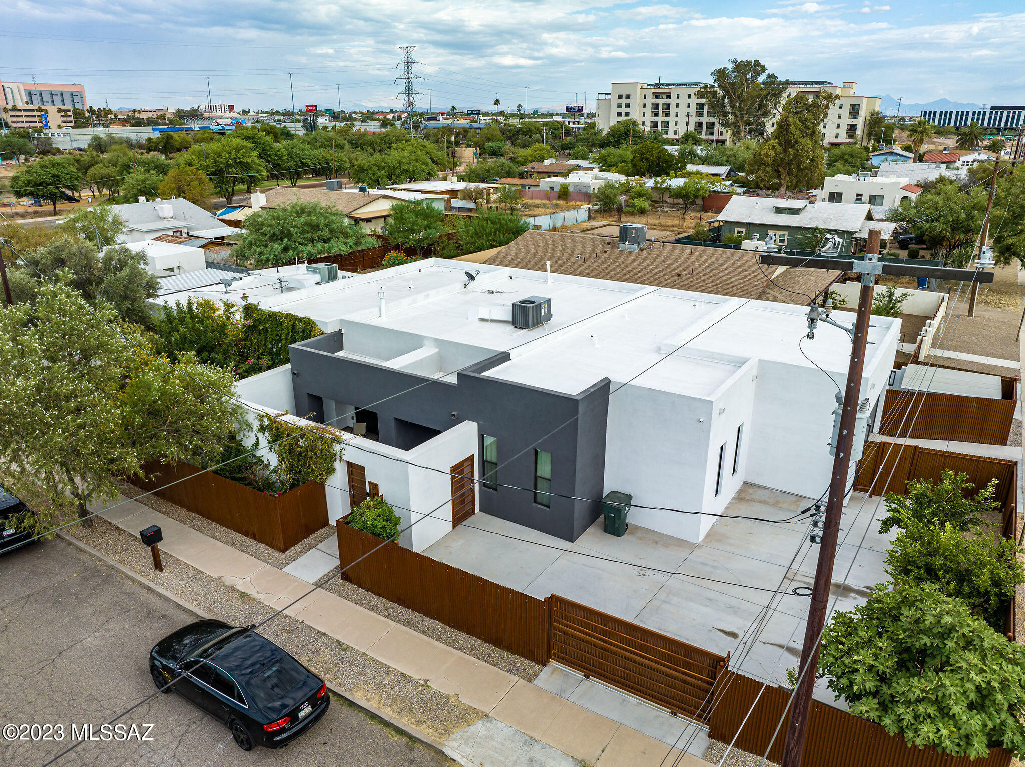 Location, Location, Location. This one of a kind newer home located in the Menlo Park Historic Neighborhood. Rillito River bike path also known as ''The Loop.'' Wonderful location 1 block from Mercado San Agustin, take the streetcar downtown or to the UofA, great restaurants, and amazing stores. This incredible newer contemporary home has an open floorplan with a large great room, black marble gas fireplace with the entire wall tiled for an amazing look.  Indoor/outdoor living with the 12' sliding glass door opening up to the front courtyard with waterfall. Multiple private patios, fire pit, and doll house/play room.
  This property sits on a large corner lot with private guest house. Corrugated steel fencing provides lots of privacy. Owner/Agent . Main home features stainless steel appliances including French door Refrigerator w/water and ice dispenser, Dishwasher, Mini Fridge, 2 ovens, Microwave, hood & wall mount pot filler, center island with quartz countertop, pendant lighting, large pantry and a laundry room. The Guest house is a 1 bedroom 1 bath with dining room, living room, remodeled kitchen and remodeled bathroom. A private front and back yard, carport and a concrete driveway to park many cars.  The master suite has two incredible walk in closets, large shower with dual shower heads, raised sinks, custom faucets and fixtures.  
Extra features include: Custom Front door,  8' interior doors. Surround sound in living room, Master bath, and both front and back porches. Security cameras around property. All TV's in home stay.  Fruit trees include:  2 lime trees, Fig tree, pomegranate tree and an apricot tree.