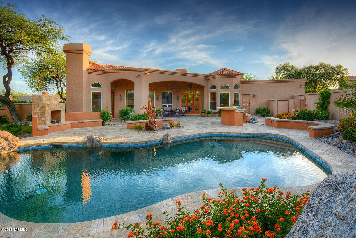 Beautiful custom home on a rare private and spacious lot with stunning views in Ventana Canyon. Wonderful floorplan with private owners suite with sitting area and fireplace, children's study area between 2 bedrooms and separate guest area with ensuite bath. Formal dining room with wet bar and fireplace.  Gourmet kitchen is open to large greatroom with wet bar and fireplace. Step outside to a resort like backyard with pool, spa, fireplace, covered patio, BBQ area and fabulous mountain vistas.