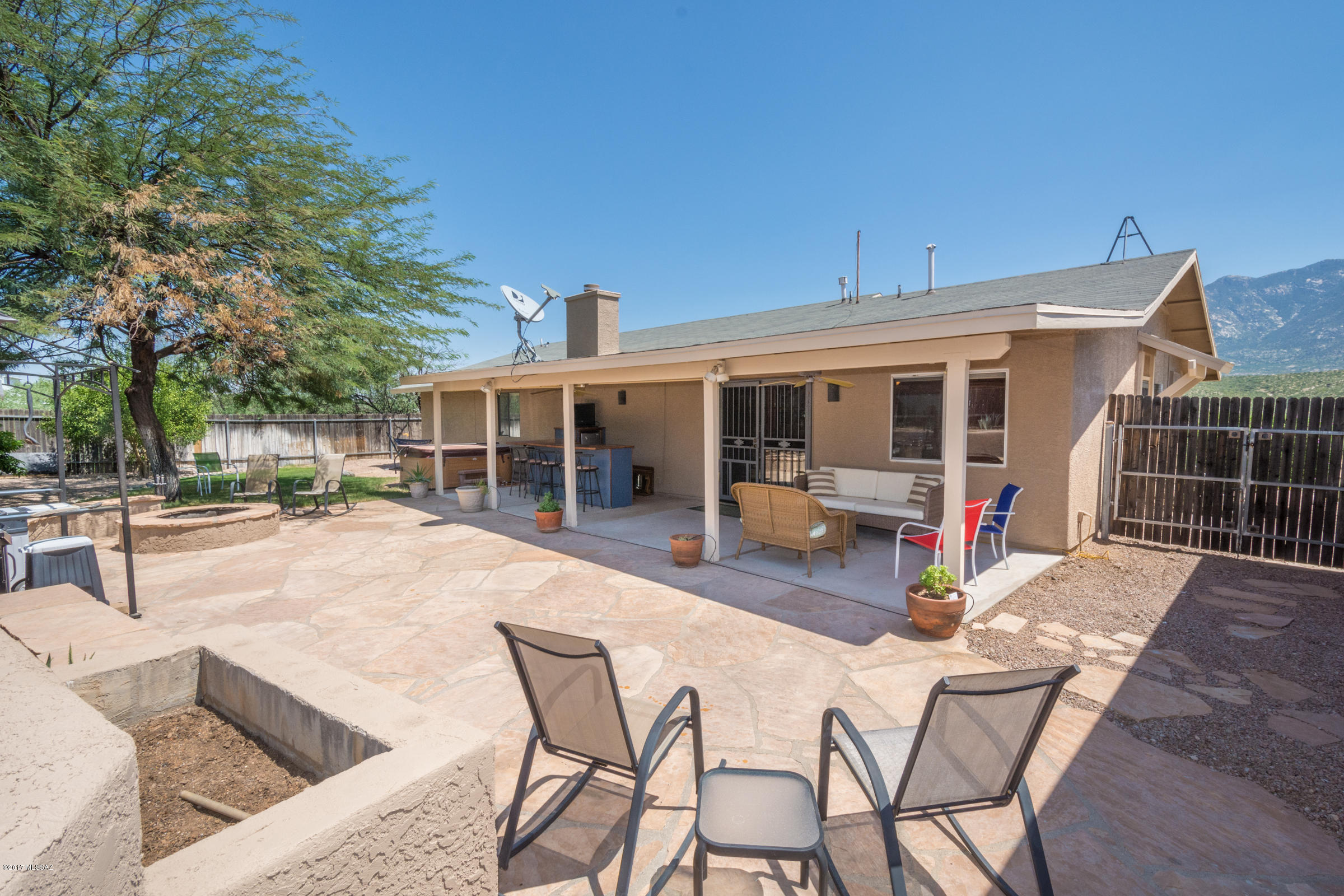 Sweeping Front Porch Views Of Mt Lemmon On A 1+ Acre Lot, 50 Amp Full RV Hookup, 2 Sheds, Zoned For Horses & No HOA; Granite Tiled Kitchen Counters/Backsplash & Stainless Appliances; Laundry Room w/Bonus Fridge, Washer, Dryer & Storage; Spacious Master Suite w/Bay Window, Make-Up Vanity & Walk-In Closet; Designer Paint, New Exterior Paint, Ceiling Fans, Delta Faucets, Dual Pane Windows, Wood Burning Fireplace, Ceramic Tile In All Traffic Areas, Custom Window Treatments & Wrought Iron Screen Doors w/Glass Inserts; Covered Flagstone Patio, Fruit Trees, Grass, Hot Tub, Fire Pit, Bar, Tool Shed/Workbench, Full Sized Carport Can Be An Easy Garage Conversion; Peaceful Area w/Great Neighbors That's Very Close To Schools, Shopping, Dining, Medical, Hiking, Riding Trails, State Park & Everything!
