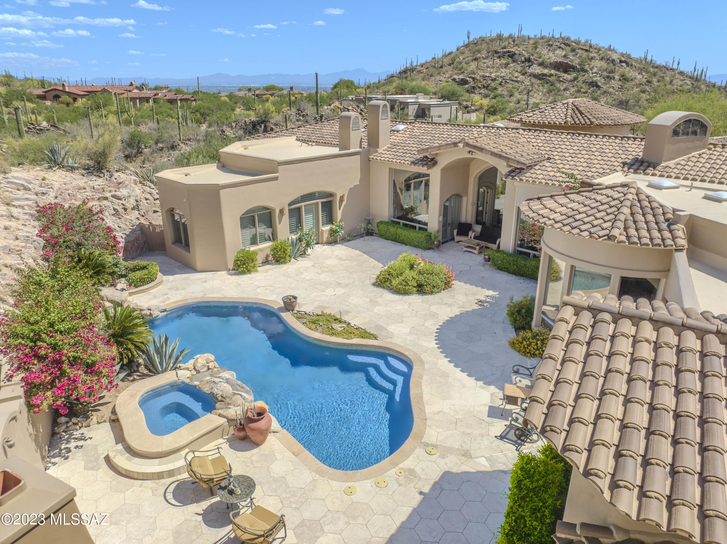 Spectacular home in the exclusive, gated The Canyons community.  This quiet and prestigious neighborhood is both secluded and close to everything, La Paloma, Ventana Canyon, La Encantada and more. Enjoy Stunning City Lights and Mountain Views from 3.3 acre lot. Home is the essence of elegance and luxury. DelBarco Stone and Bamboo flooring. Sculptured and Wood beamed Ceilings, Magnificence of Oversized Picture Windows throughout. Owner's Suite is Grand and Elegant; featuring Fireplace, Sitting Room, Dual Closets, Dual Bathrooms and Private Patio. All Bedrooms with EnSuite Baths. Temp Controlled Wine Room. Impressive Resort Style Backyard with Pool/Spa, Natural Rock Waterfall and Fireplace surrounded by Mountain and Rock Cliff Views for the Utmost of Privacy.  No detail has been overlooked!!