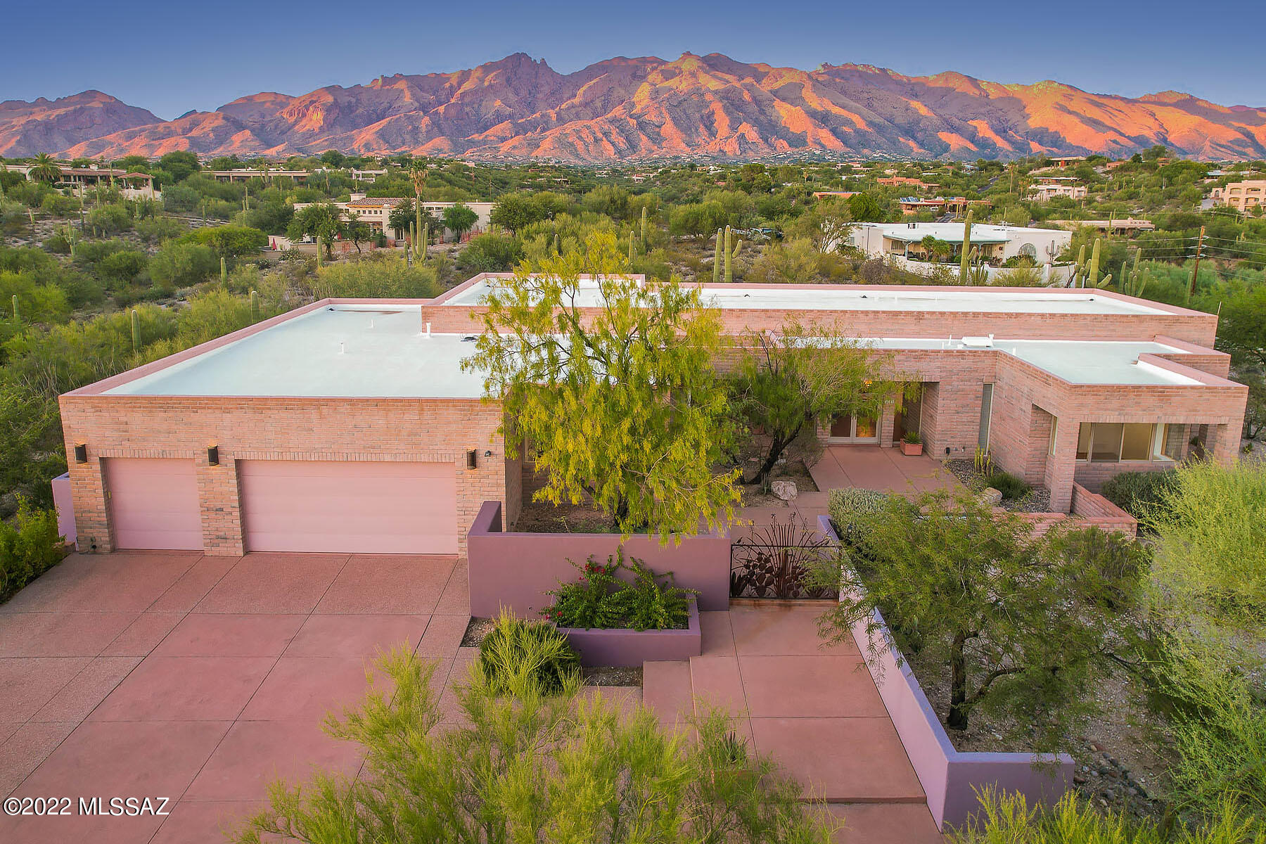 Spectacular mountain & sunset view home in gated Bellas Catalinas Estate. 4 BR/3BA, 3725 sq ft home w/open floor plan is perfect for casual living & entertaining. A warm contemporary masonry custom home. Soaring ceilings, Walls of glass brings the outside in. Concrete floors/countertops & custom cabinetry throughout. Kitchen has island w/ sitting and a Sub Zero. Primary bath boast a jetted tub, grand walk-in closet. Additional adjoining lot included for a total of 1.74 acres! Plenty of room to add a guest house if desired. A studio or 4th bedroom in separate wing with front courtyard access could make a great office. Oversized 3-car garage includes additional storage room, built-in storage rm @ 3rd bay, built-in cabinets w/sliding door access to covered patio is great for hobbies. Home designed by Donald Kornberg. LA related to Seller.